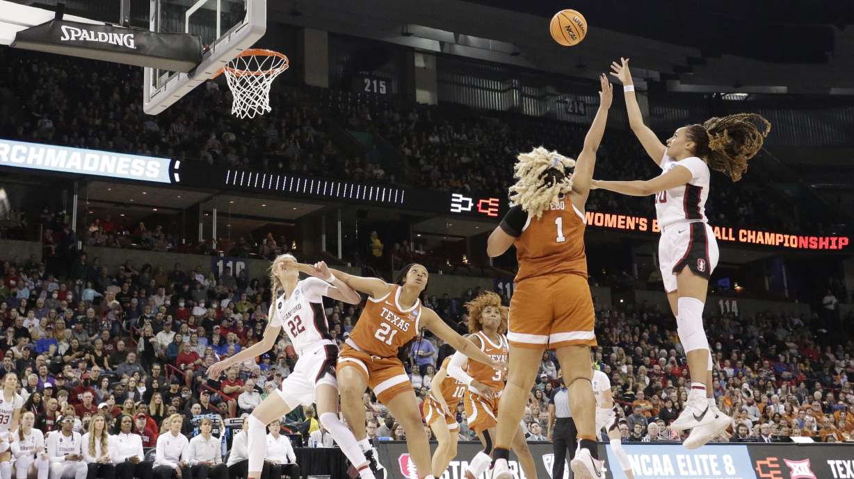 Stanford guard Haley Jones, right, shoots over Texas center Lauren Ebo (1) during the second half of a college basketball game in the Elite 8 round of the NCAA tournament, Sunday, March 27, 2022, in Spokane, Wash.