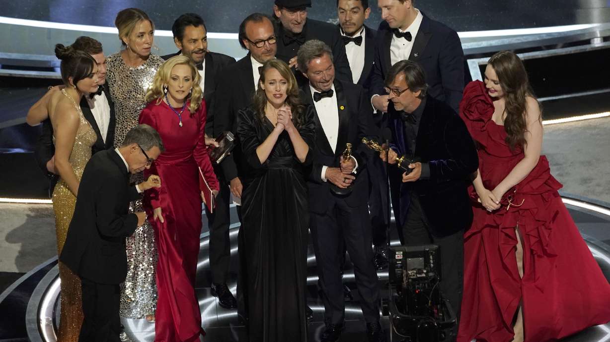 The cast and crew of "CODA" accept the award for best picture at the Oscars on Sunday, at the Dolby Theatre in Los Angeles.