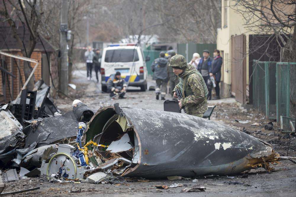 A Ukrainian Army soldier inspects fragments of a downed aircraft in Kyiv, Ukraine, Feb. 25. With its aspirations for a quick victory dashed by a stiff Ukrainian resistance, Russia has increasingly focused on grinding down Ukraine’s military in the east in the hope of forcing Kyiv into surrendering part of the country’s eastern territory to end the war.