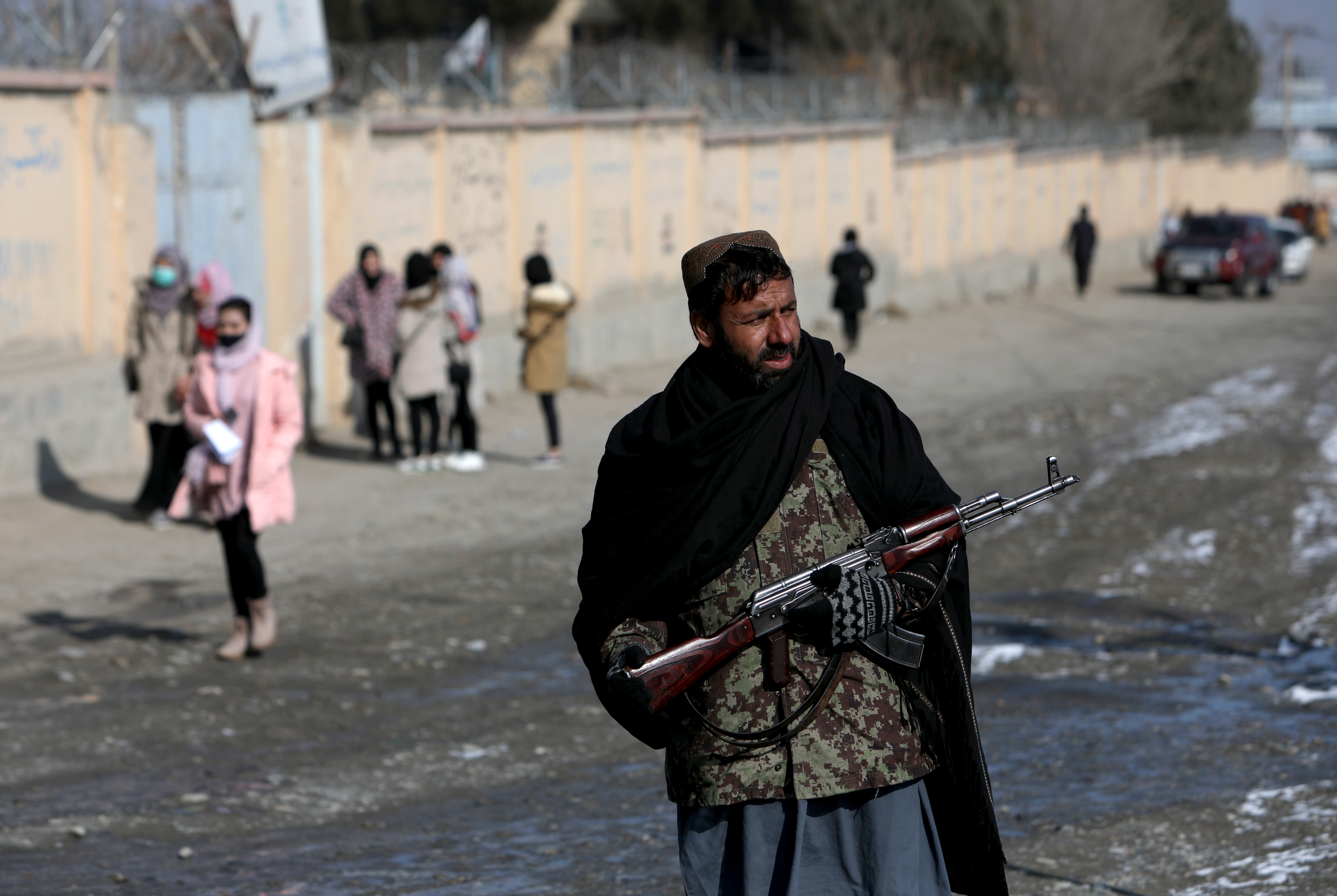 A Taliban fighter guards a street in Kabul, Afghanistan, Dec. 16, 2021. Afghanistan's Taliban has instructed all government employees to wear a beard and adhere to a dress code or risk being fired, the latest of several new restrictions imposed by the hardline Islamist administration.