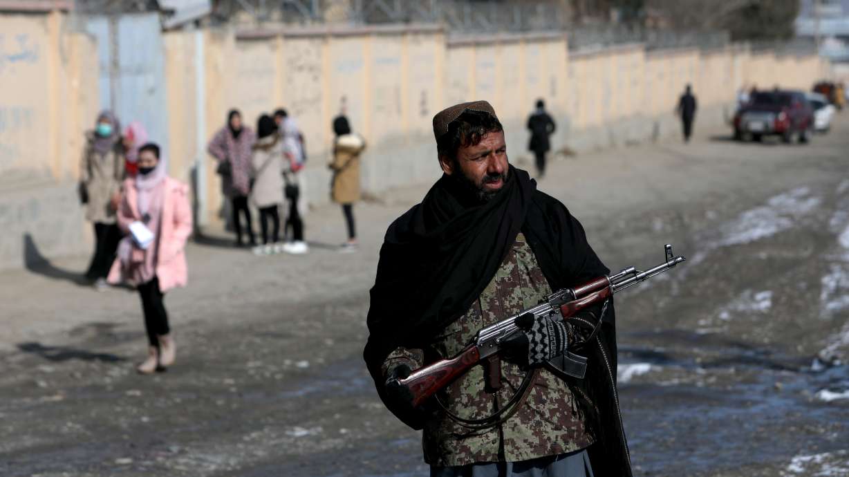 A Taliban fighter guards a street in Kabul, Afghanistan, Dec. 16, 2021. Afghanistan's Taliban has instructed all government employees to wear a beard and adhere to a dress code or risk being fired, the latest of several new restrictions imposed by the hardline Islamist administration.