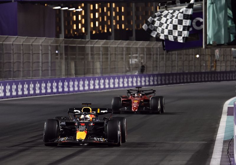 Formula One F1 - Saudi Arabia Grand Prix - Jeddah Corniche Circuit, Jeddah, Saudi Arabia - March 27, 2022 Red Bull's Max Verstappen crosses the line to win the race ahead of Ferrari's Charles Leclerc