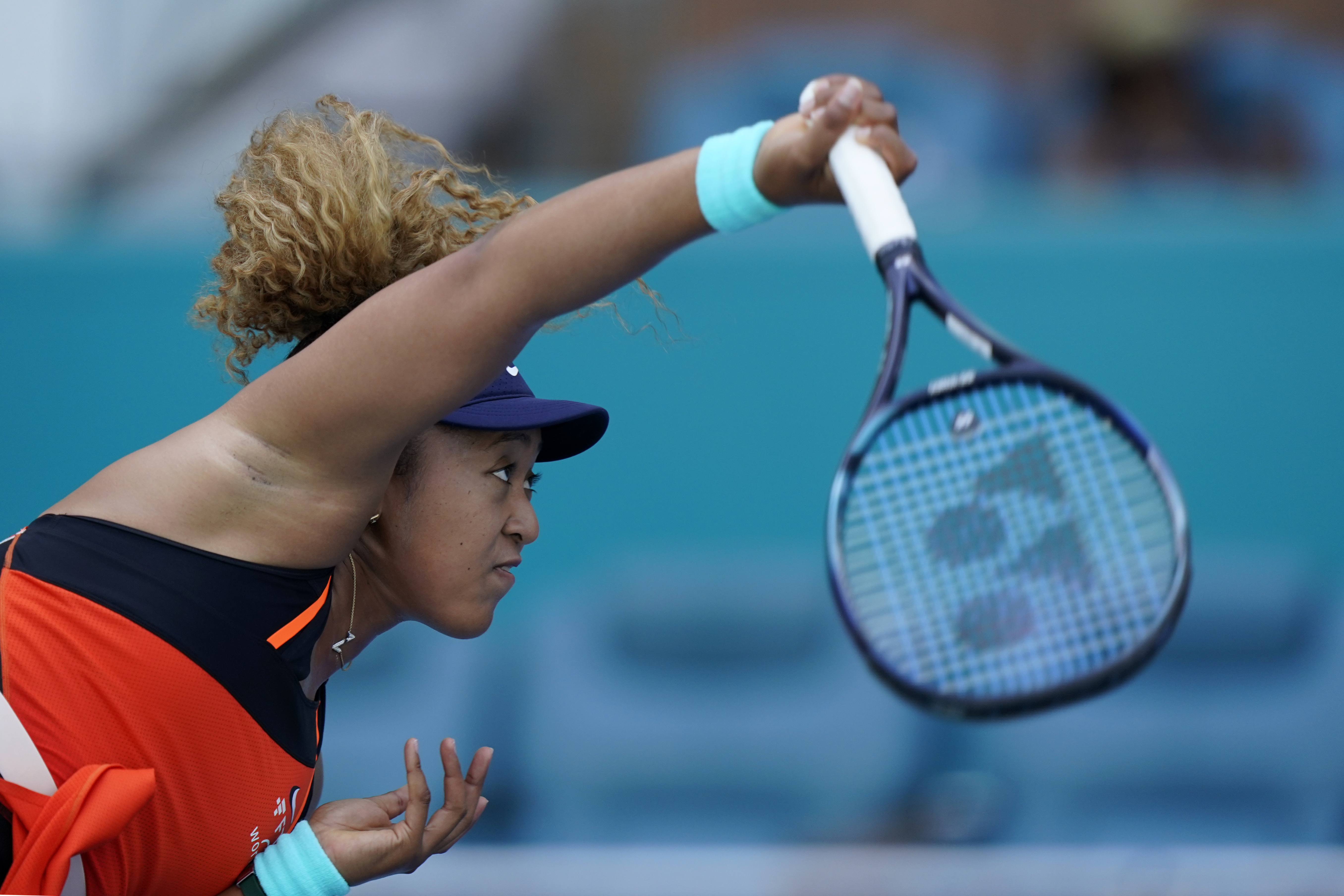 Naomi Osaka, of Japan, serves to Alison Riske during the Miami Open tennis tournament, Monday, March 28, 2022, in Miami Gardens, Fla. 