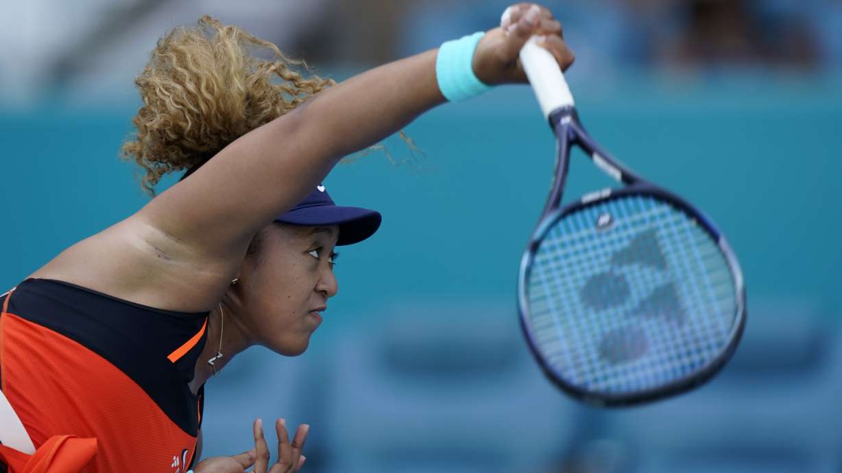 Naomi Osaka, of Japan, serves to Alison Riske during the Miami Open tennis tournament, Monday, March 28, 2022, in Miami Gardens, Fla.