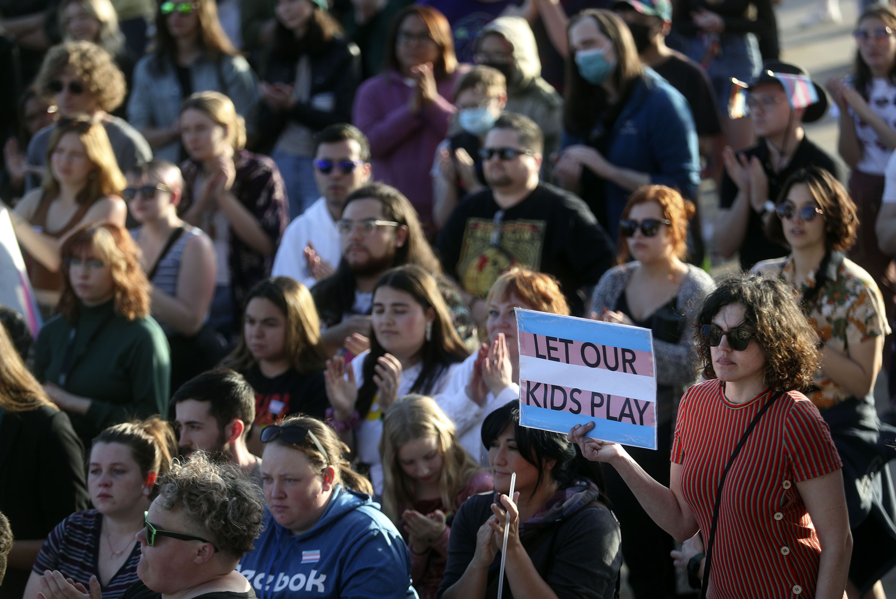 Carinne James holds a “Let our kids play” sign during a rally to support transgender youths outside of the Capitol in Salt Lake City on March 24. U.S. Olympic and Paralympic Committee leaders said Monday that Utah’s bid for another Winter Games as soon as 2030 will continue to be backed despite the Utah Legislature banning youth transgender athletes from competing in girls sports but warned the new law is already raising concerns.