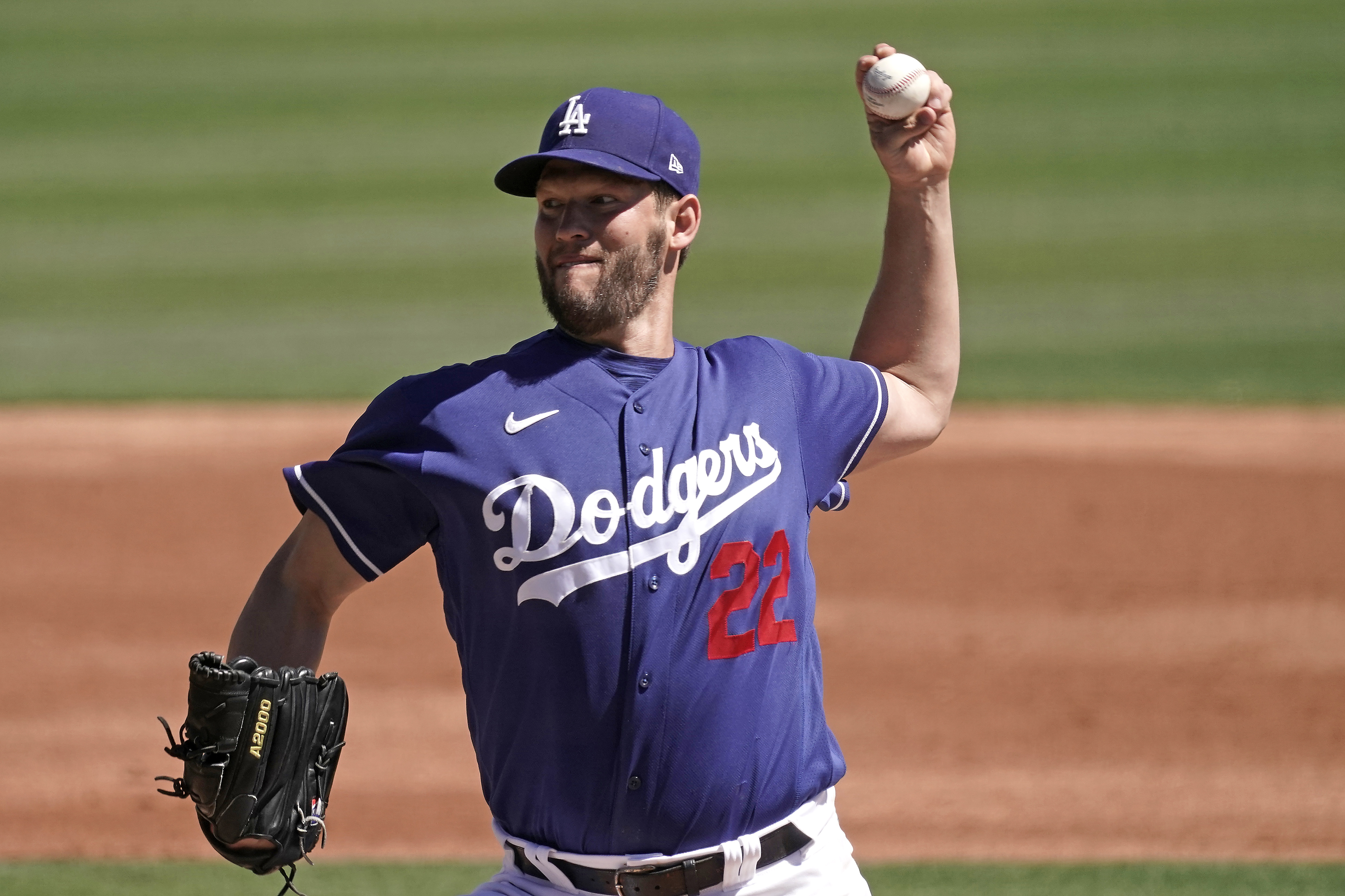 Los Angeles Dodgers starting pitcher Clayton Kershaw throws during the first inning of a spring training baseball game against the Cleveland Guardians Wednesday, March 23, 2022, in Glendale, Ariz. 