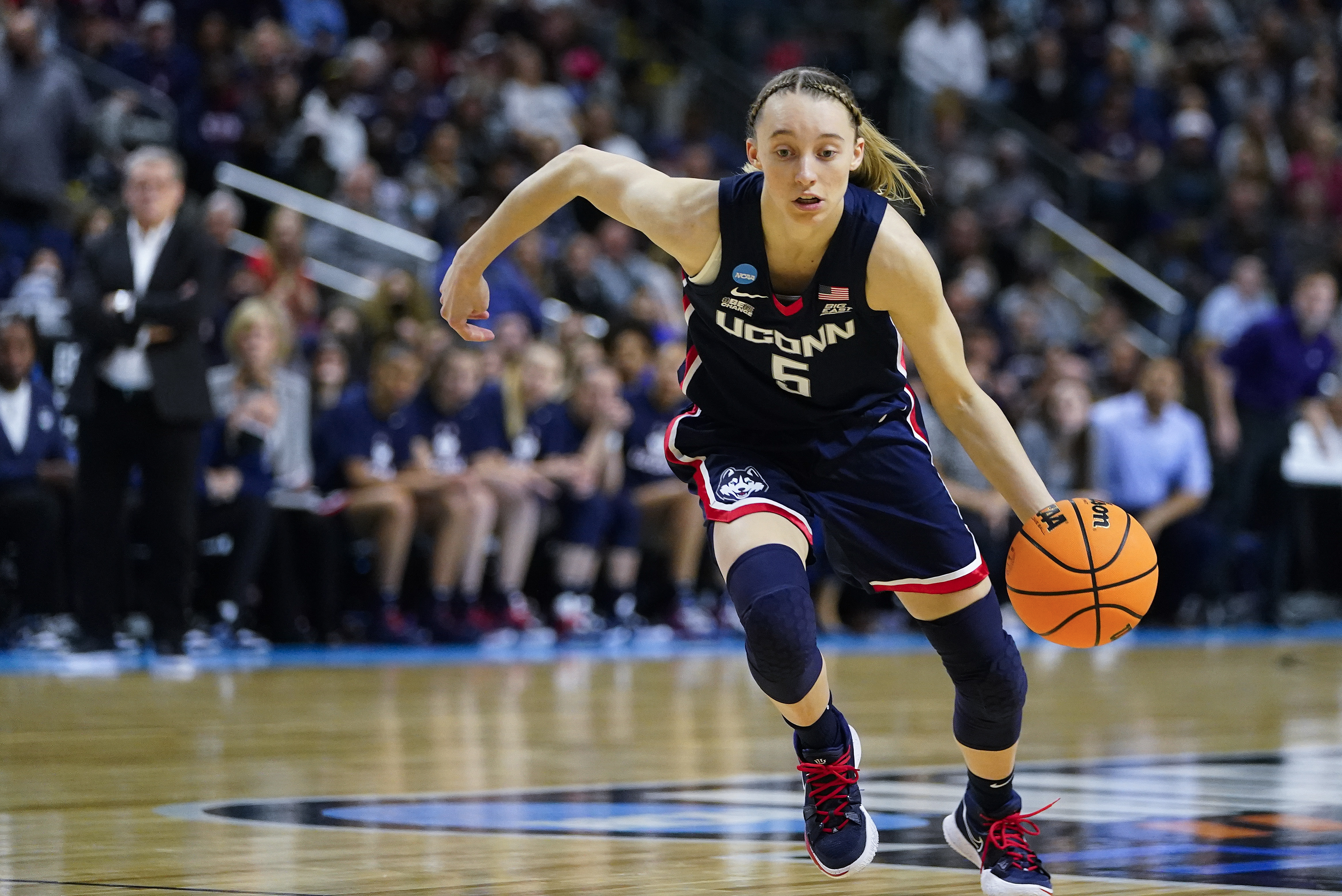 Connecticut guard Paige Bueckers (5) drives to the lane against NC State during the first quarter of the East Regional final college basketball game of the NCAA women's tournament, Monday, March 28, 2022, in Bridgeport, Conn. 