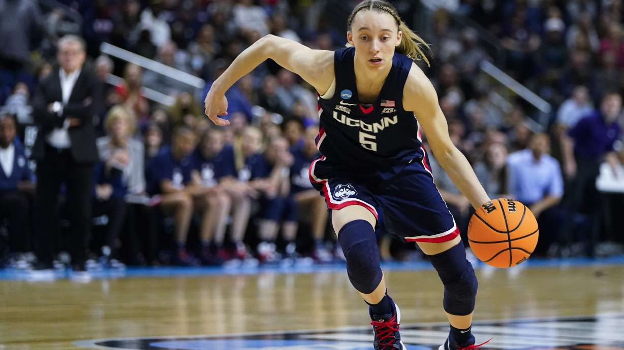 Connecticut guard Paige Bueckers (5) drives to the lane against NC State during the first quarter of the East Regional final college basketball game of the NCAA women's tournament, Monday, March 28, 2022, in Bridgeport, Conn.