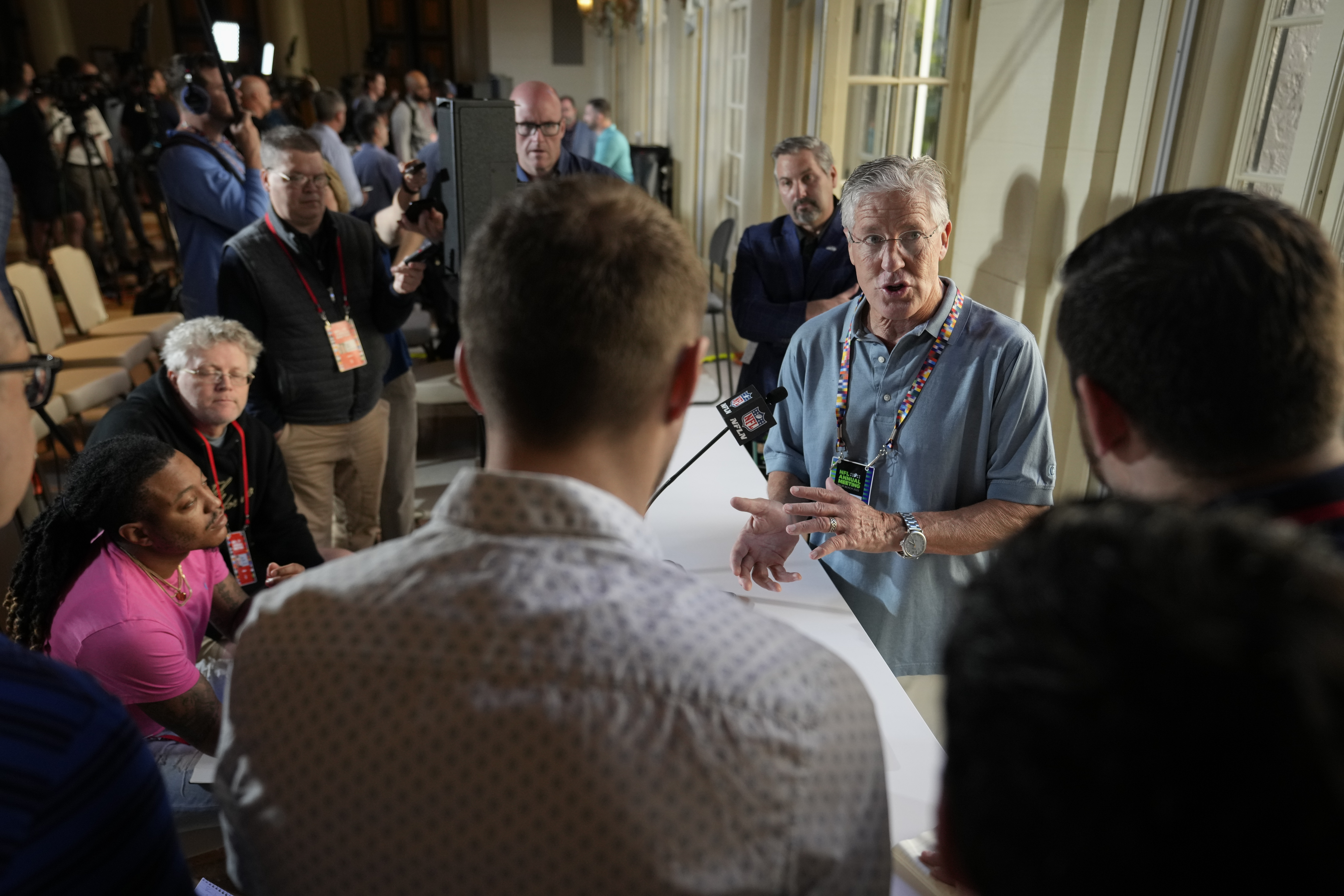 Seattle Seahawks head coach Pete Carroll, second right, speaks to reporters during a coaches press availability at the NFL owner's meeting, Tuesday, March 29, 2022, at The Breakers resort in Palm Beach, Fla. 