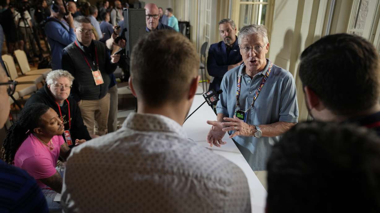 Seattle Seahawks head coach Pete Carroll, second right, speaks to reporters during a coaches press availability at the NFL owner's meeting, Tuesday, March 29, 2022, at The Breakers resort in Palm Beach, Fla.