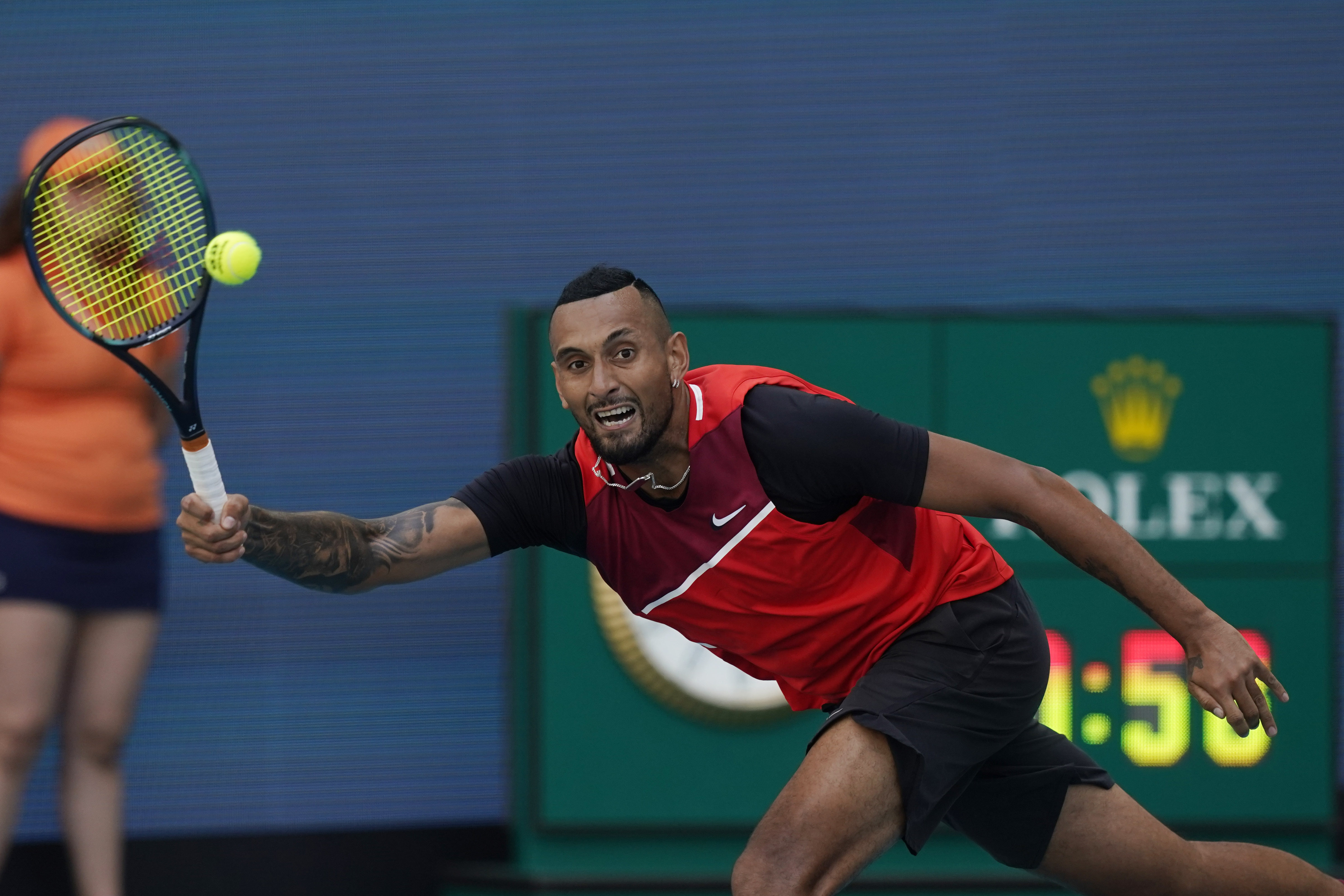 Nick Kyrgios of Australia, returns the ball to Fabio Fognini of Italy, during the Miami Open tennis tournament, Sunday, March 27, 2022, in Miami Gardens, Fla. 