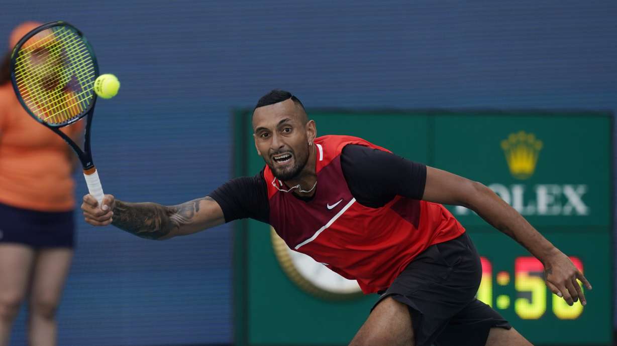 Nick Kyrgios of Australia, returns the ball to Fabio Fognini of Italy, during the Miami Open tennis tournament, Sunday, March 27, 2022, in Miami Gardens, Fla.