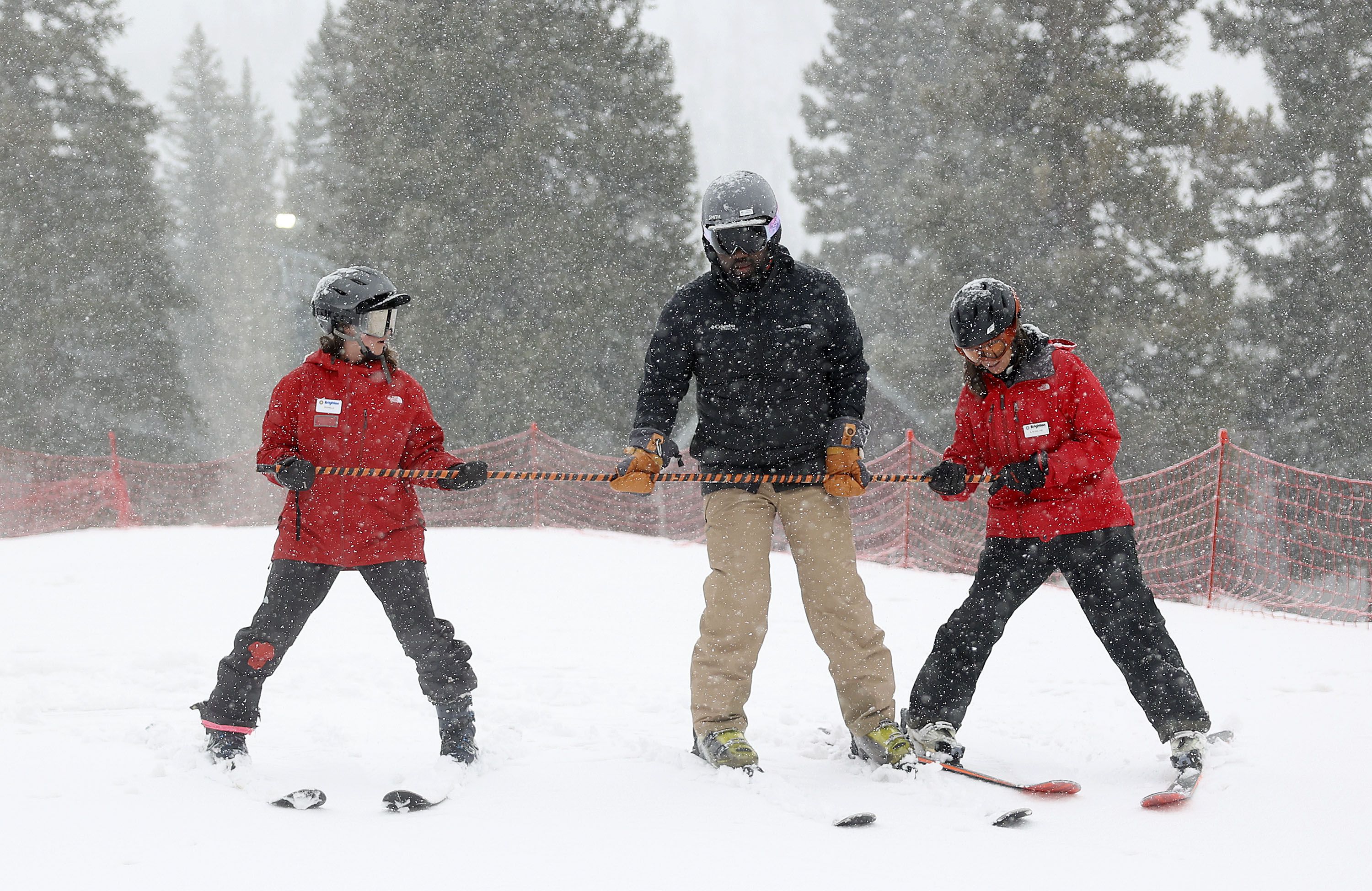 Brighton ski instructors Rochelle Erskine, left, and Leslie Blank, right, teach Freebody Mensah how to ski during Discover Winter, a program aimed at increasing diversity in winter sports, at Brighton Resort on Monday, March 28.