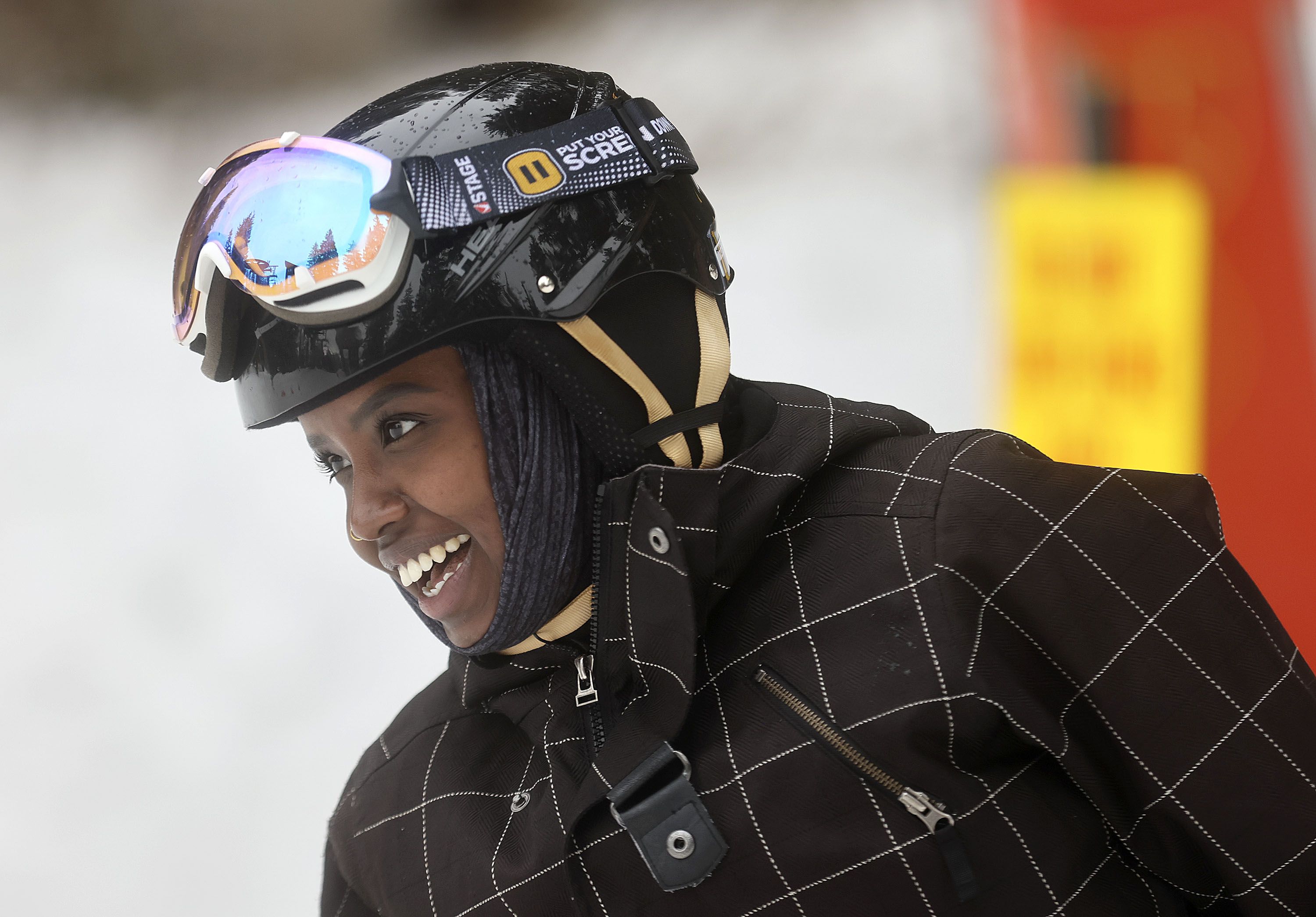 Hawa Dahir smiles as she learns to snowboard as part of Discover Winter, a program aimed at increasing diversity in winter sports, at Brighton Resort on Monday, March 28, 2022.