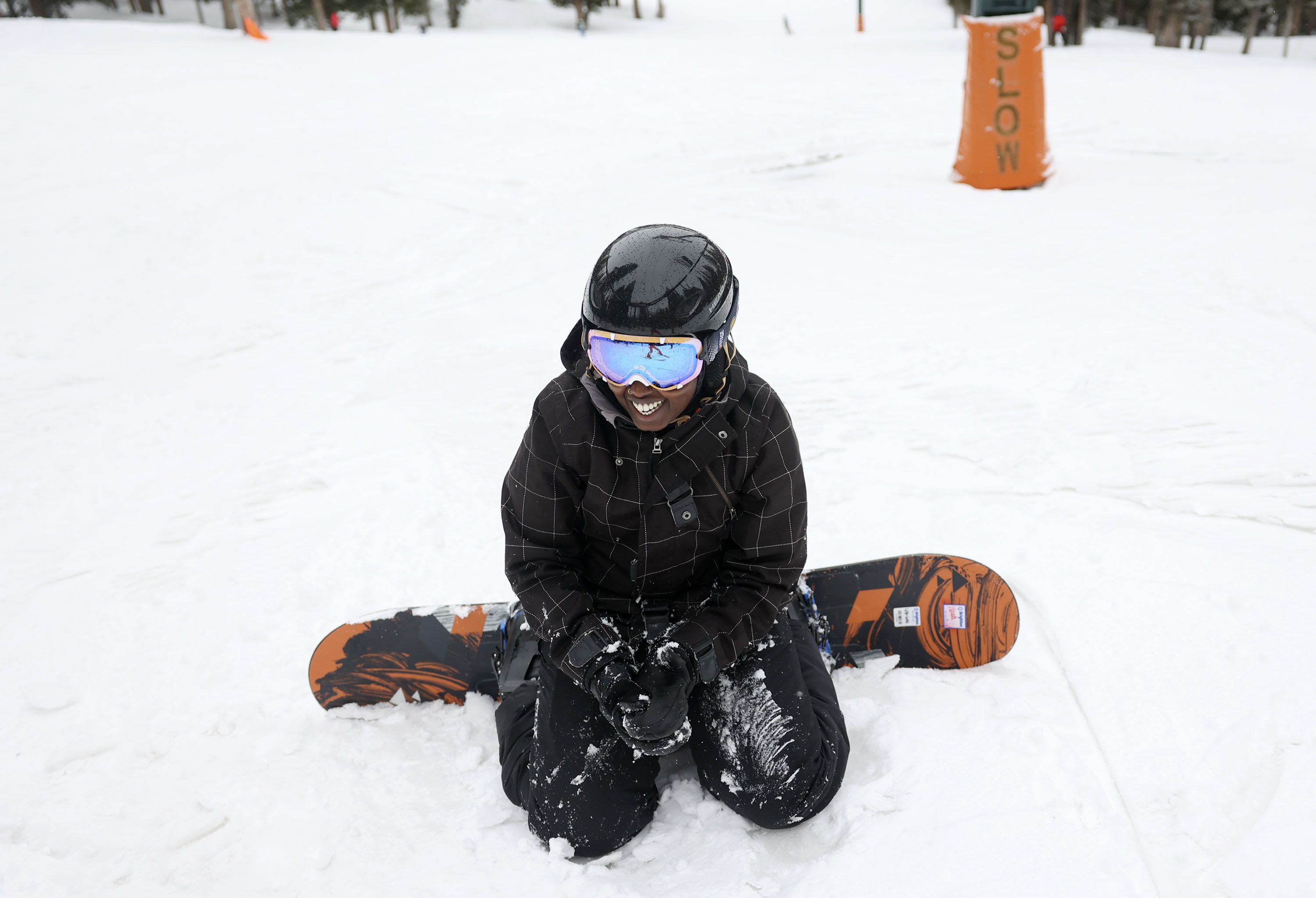 Hawa Dahir learns to snowboard as part of Discover Winter, a program aimed at increasing diversity in winter sports, at Brighton Resort on Monday, March 28, 2022.