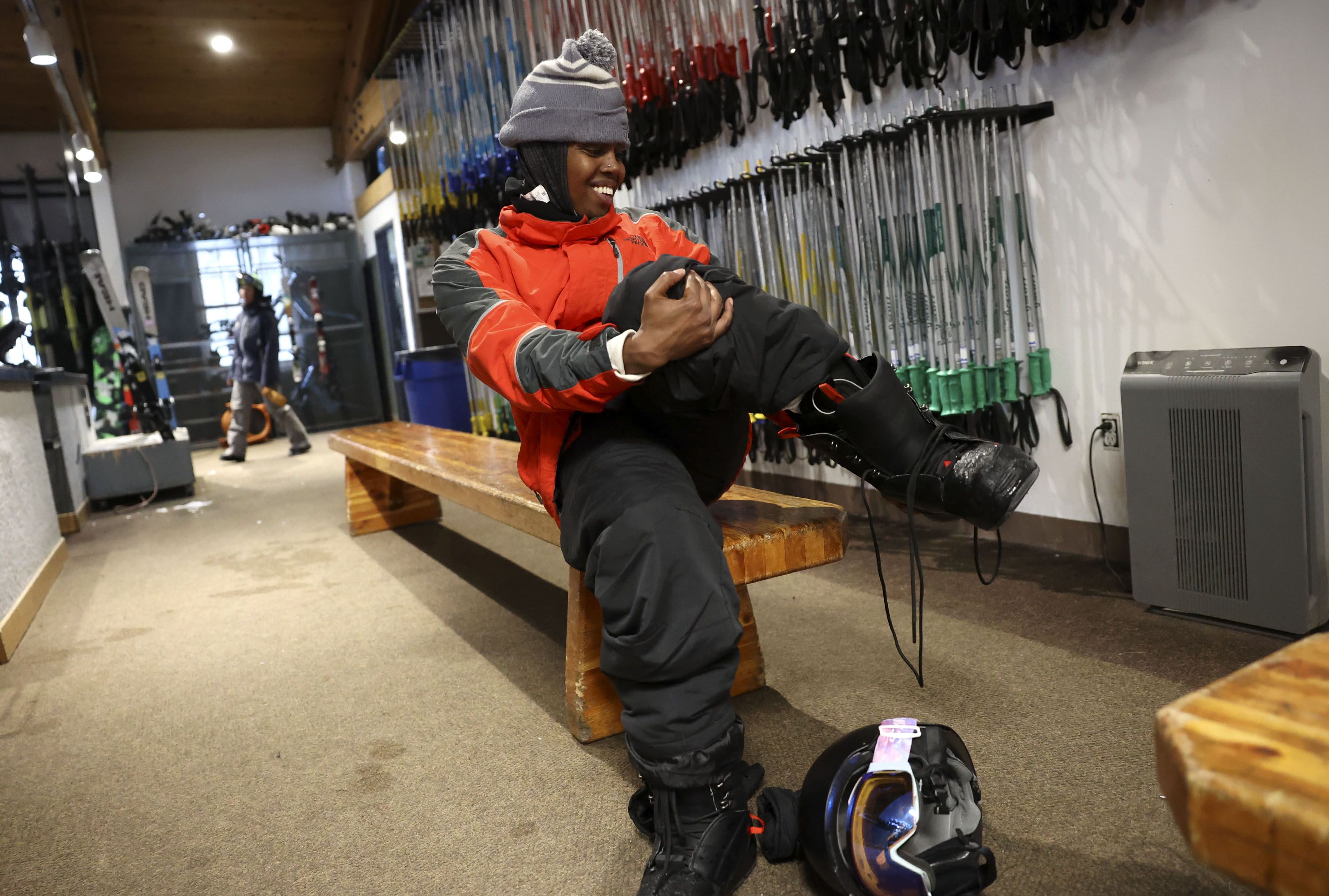 Ahmed Dahir takes off his boots after a snowboarding lesson that was part of Discover Winter, a program aimed at increasing diversity in winter sports, at Brighton Resort on Monday, March 28.