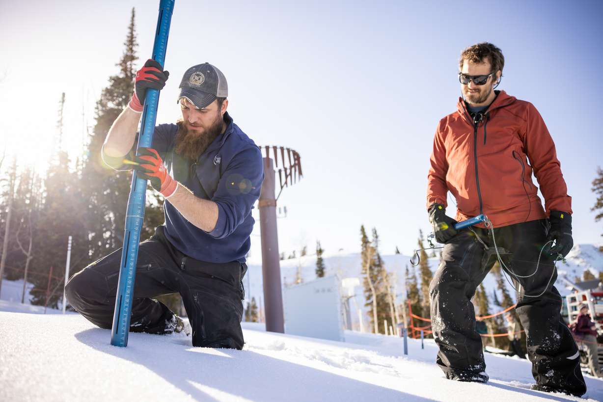 Justin Byington and Dave Eiriksson, both hydrologists for the Utah Snow Survey, demonstrate how they take snow core samples during a media tour of the Utah Snow Survey’s Powder Mountain SNOTEL Site at the ski resort in Eden on Thursday.
