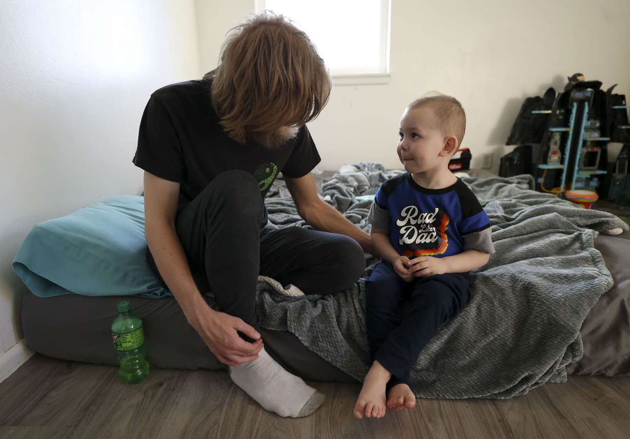 Justin Francis Sr. plays with his son, Justin Lee Francis, 3, at their home in Salt Lake City on Feb. 11. Justin Lee Francis is still recovering from COVID-19 after being intubated at Primary Children’s Hospital.