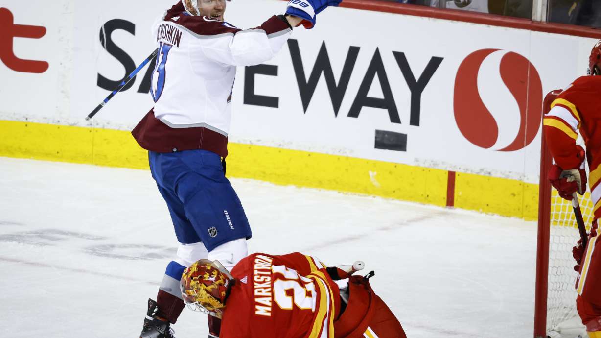 Colorado Avalanche right wing Valeri Nichushkin (13) celebrates his goal as Calgary Flames goalie Jacob Markstrom picks himself up during the third period of an NHL hockey game Tuesday, March 29, 2022 in Calgary, Alberta.