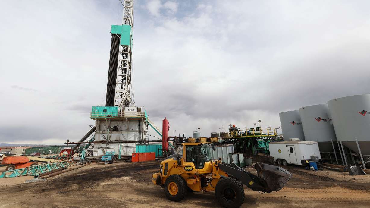 A worker operates a loader around the pad as a rig drills a well near Roosevelt on Sunday, March 13. Citing more than 4,600 oil and gas permits he says are languishing under the purview of the Interior Department, Rep. Blake Moore, R-Utah, introduced legislation Wednesday to hold the agency accountable.