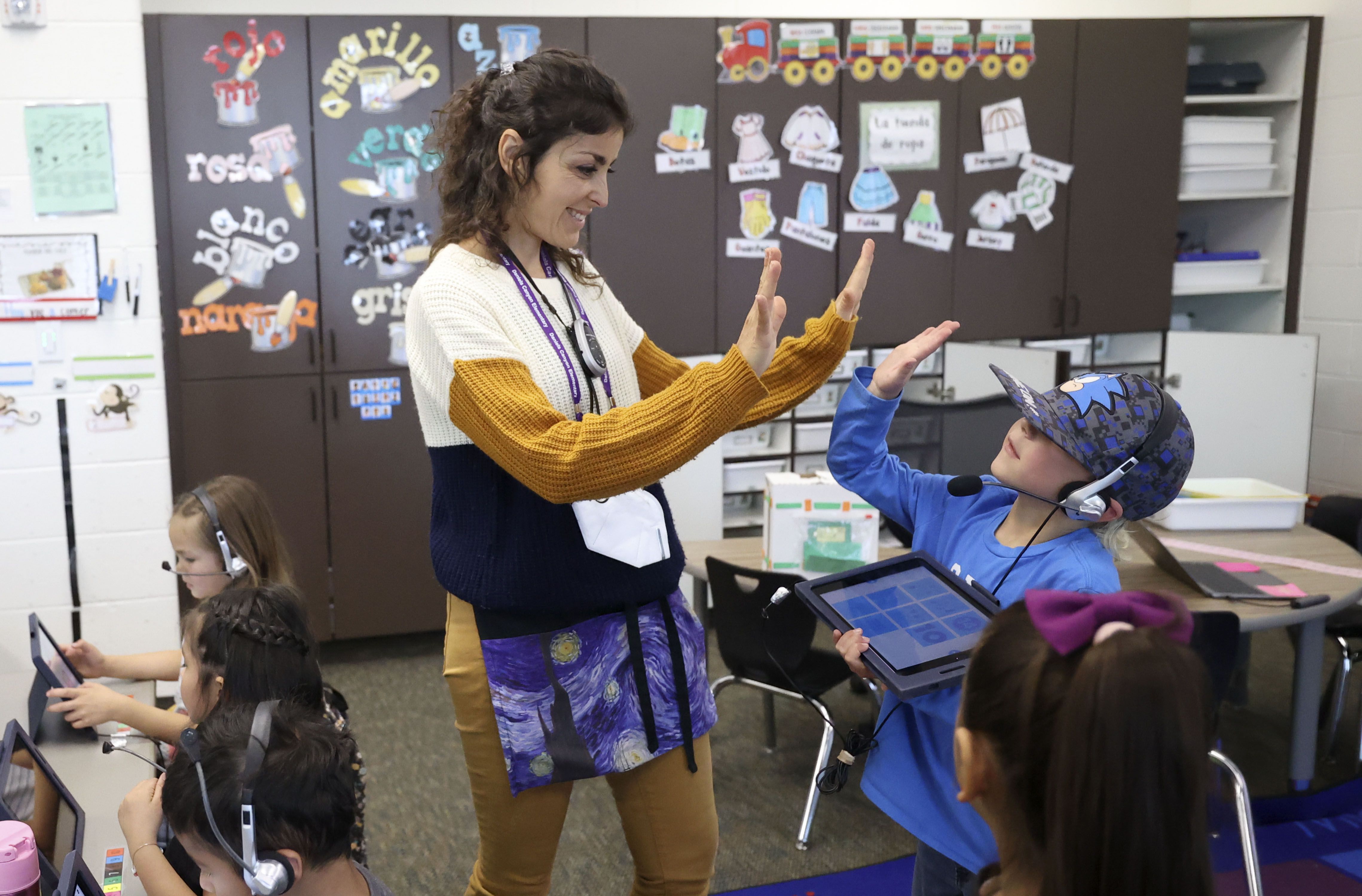 Spanish immersion kindergarten teacher Susana Perez high-fives Murphy Ashby during class at Daniels Canyon Elementary School in Heber City on Tuesday.