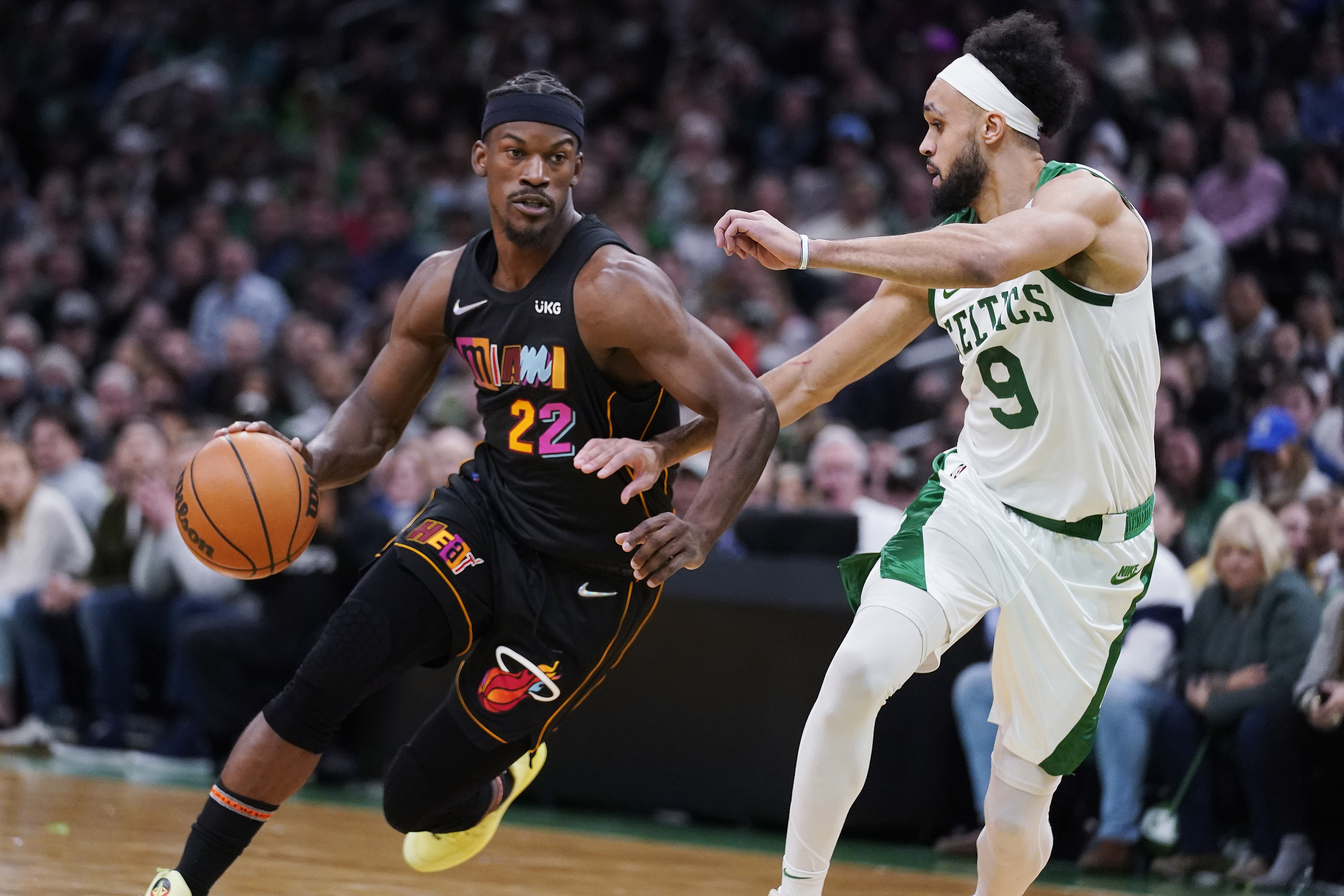Miami Heat forward Jimmy Butler (22) drives to the basket against Boston Celtics guard Derrick White (9) during the second half of an NBA basketball game Wednesday, March 30, 2022, in Boston. 