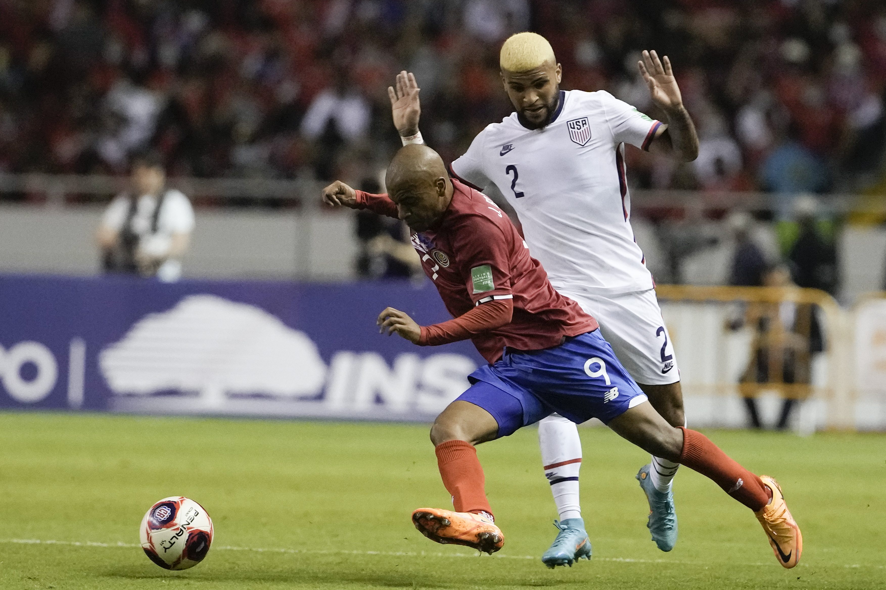 United States' Deandre Yedlin, right, and Costa Rica's Jewison Bennette battle for the ball during a qualifying soccer match for the FIFA World Cup Qatar 2022 in San Jose, Costa Rica, Wednesday, March 30, 2022. 