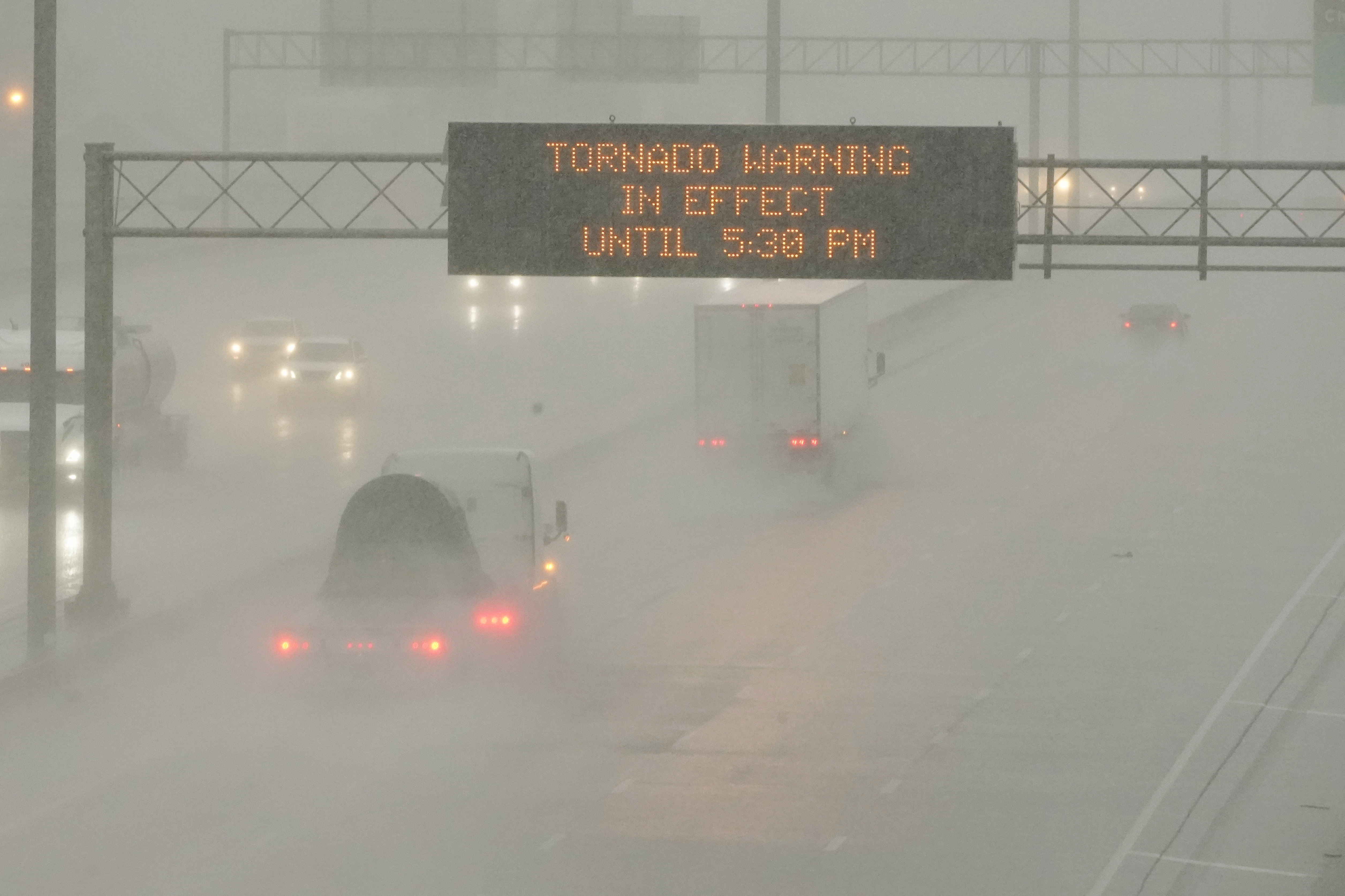 The Mississippi Department of Transportation digital message board warns drivers along I-55 southbound in Jackson of a tornado warning during a rainstorm during the outbreak of severe weather in the state, Wednesday. Severe storms raced across the Deep South, killing two in the Florida Panhandle.