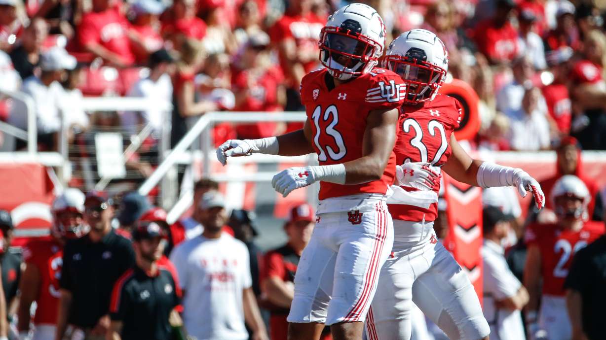 Utah wide receiver Munir McClain (13) and Utah linebacker Karene Reid (32) celebrates the victory against Washington State during an NCAA college football game at Rice-Eccles Stadium on Saturday, Sept. 25, 2021 in Salt Lake City. Utah won the game 24-13.