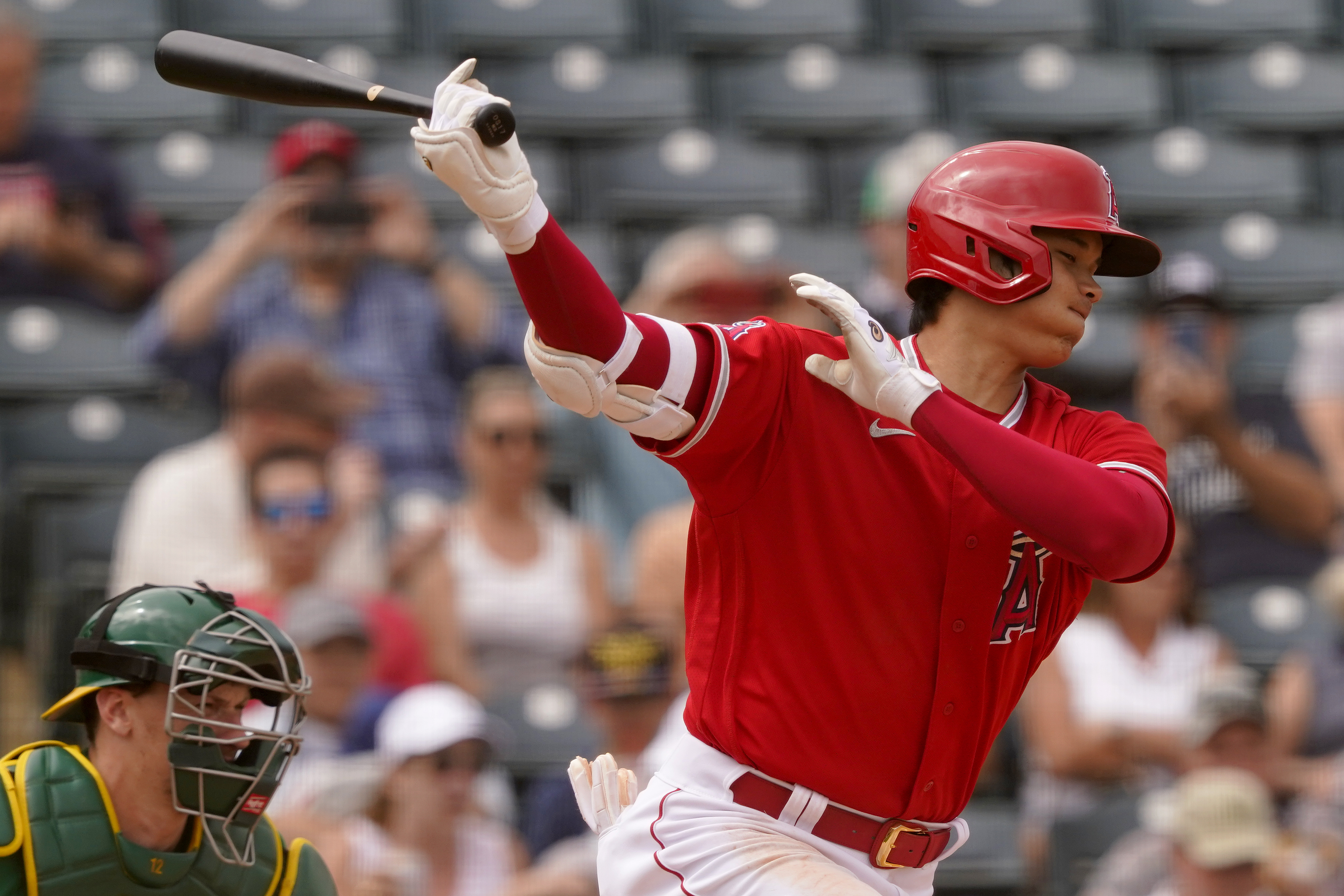 Los Angeles Angels' Shohei Ohtani strikes out against the Oakland Athletics during the third inning of a spring training baseball game, Monday, March 28, 2022, in Tempe, Ariz.