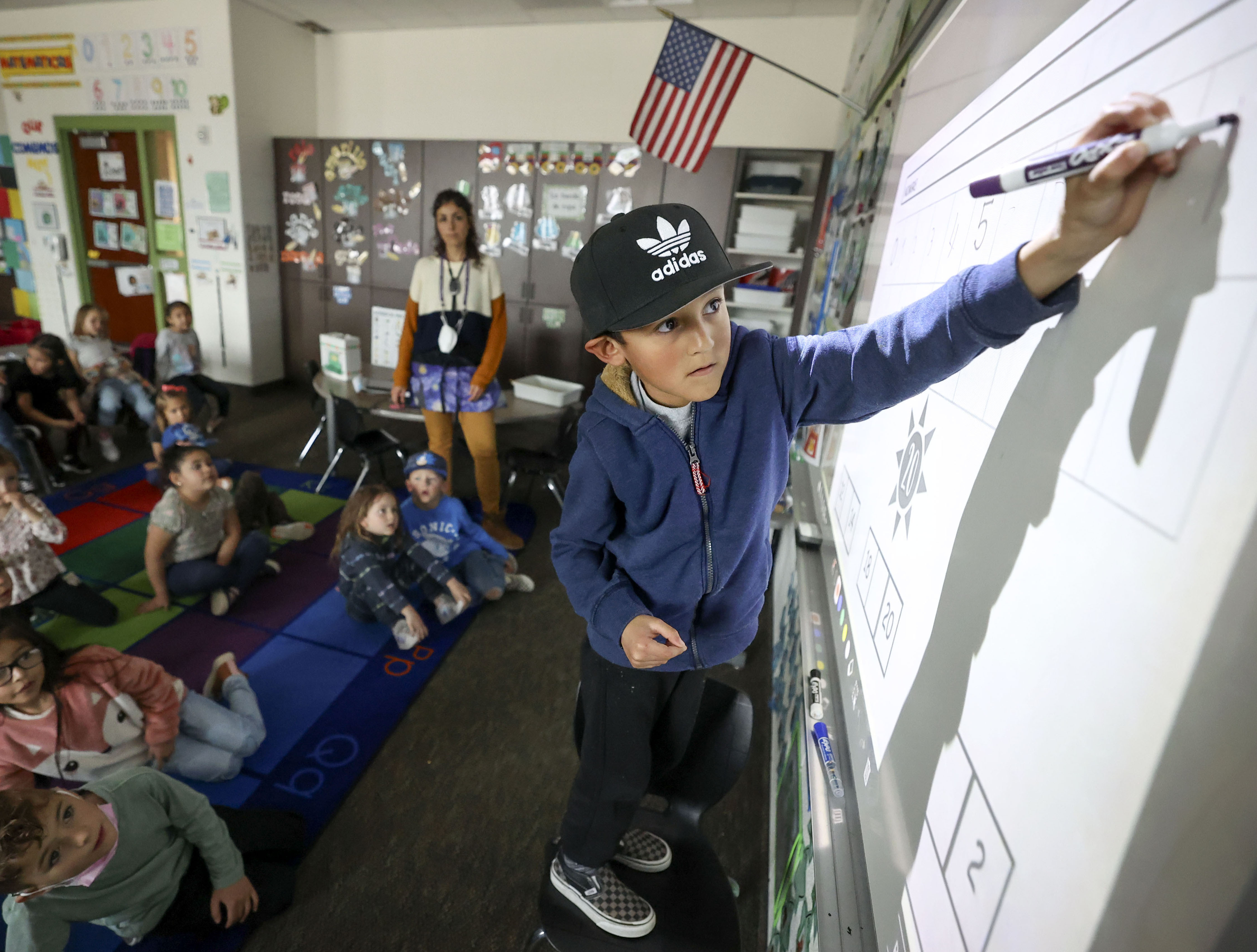 Jayden Garcia writes numbers on the board during Spanish language kindergarten at Daniels Canyon Elementary School in Heber City on Tuesday.