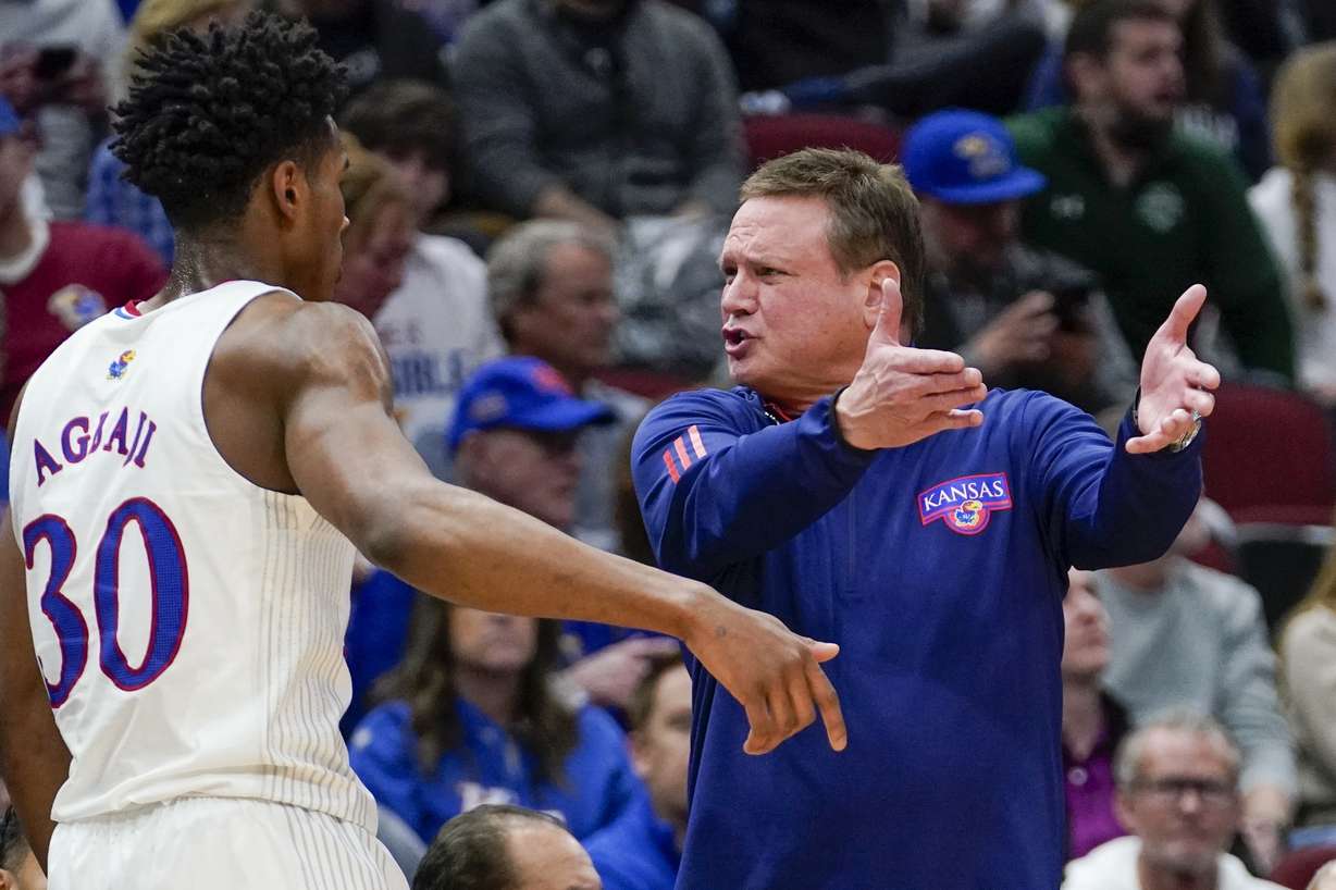 Kansas head coach Bill Self talks to Ochai Agbaji during the first half of a college basketball game in the Elite 8 round of the NCAA tournament Sunday, March 27, 2022, in Chicago.
