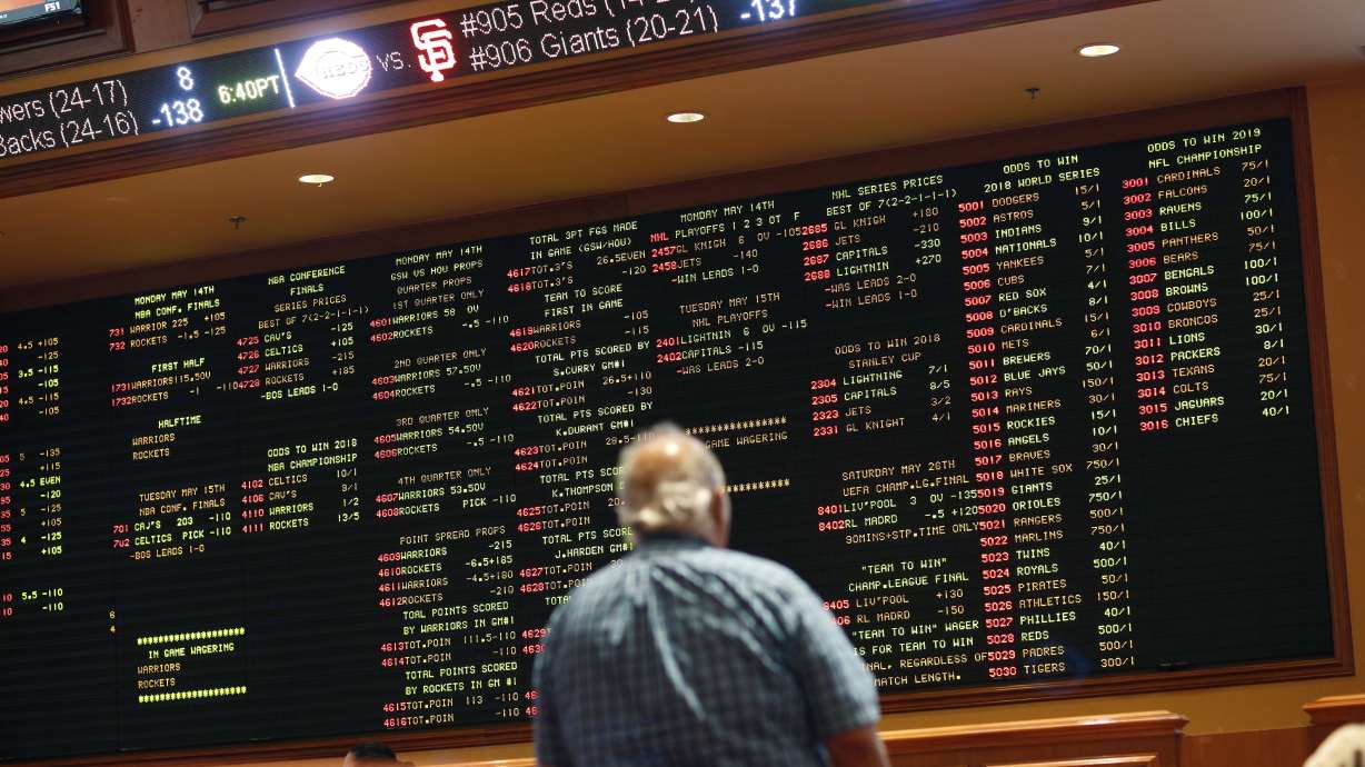 FILE - In this May 14, 2018 file photo, betting odds are displayed on a board in the sports book at a hotel casino in Las Vegas. A former minor league pitcher was the ringleader of an illegal sports betting operation in California that included current and former pro athletes, federal prosecutors said. Wayne Nix agreed to plead guilty to conspiring to run an illegal gambling operation, Thursday, March 31, 2022