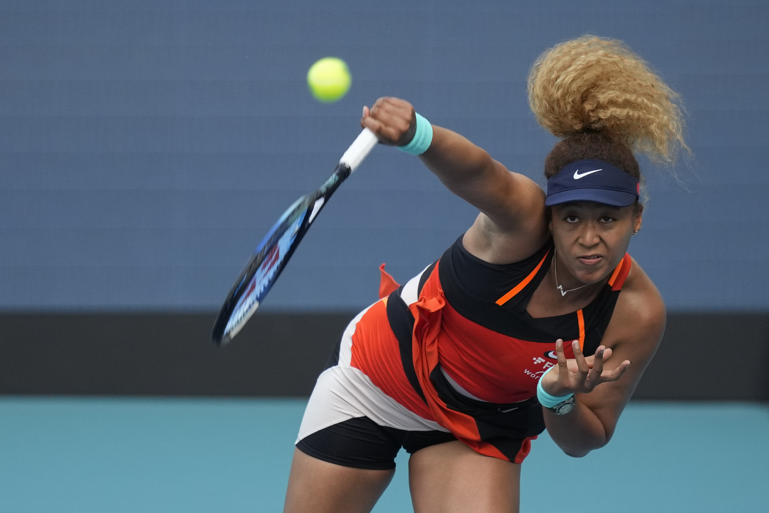 Naomi Osaka of Japan serves in her women's semifinal match against Belinda Bencic of Switzerland, at the Miami Open tennis tournament, Thursday, March 31, 2022, in Miami Gardens, Fla. 