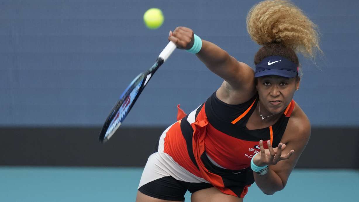 Naomi Osaka of Japan serves in her women's semifinal match against Belinda Bencic of Switzerland, at the Miami Open tennis tournament, Thursday, March 31, 2022, in Miami Gardens, Fla.