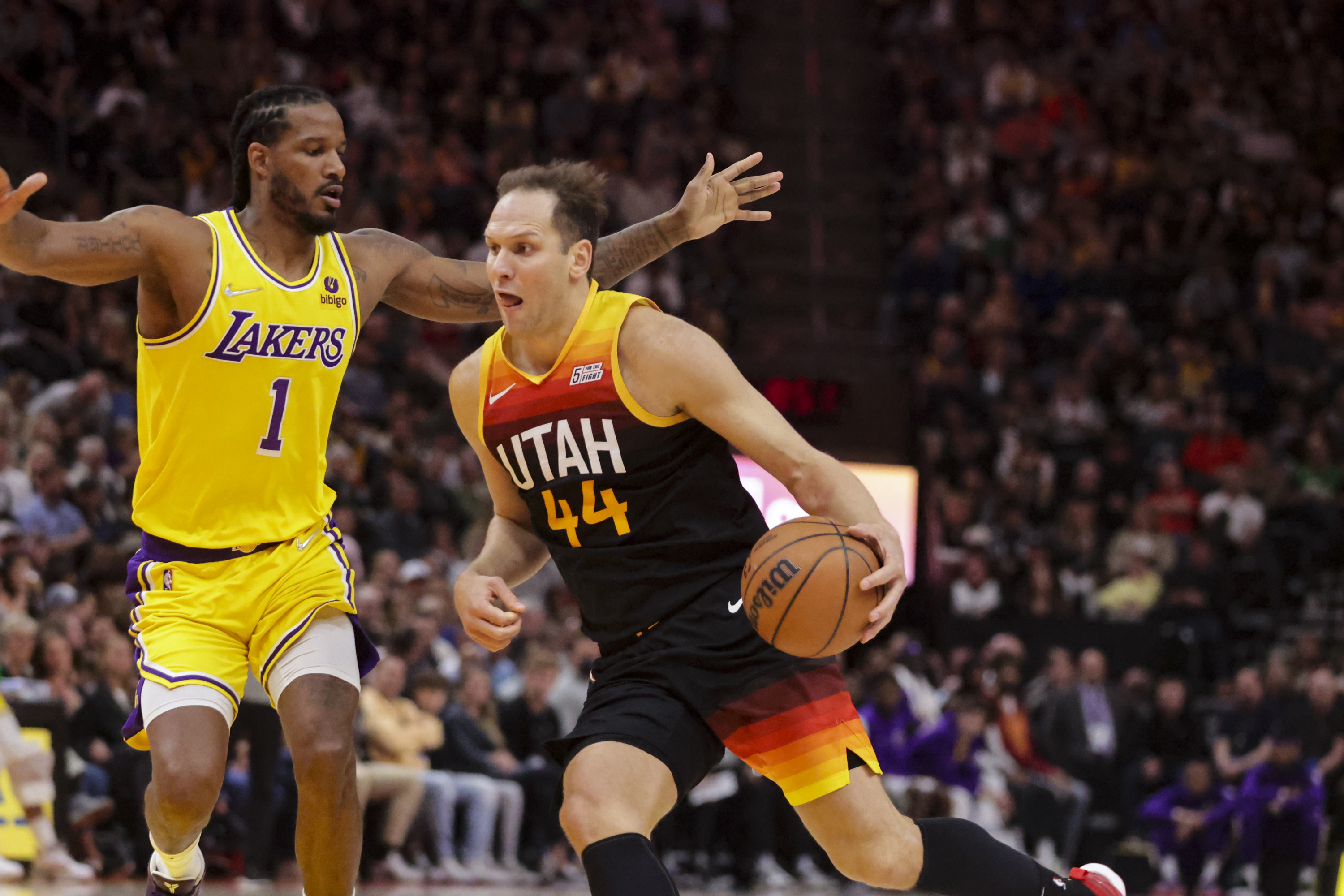 Utah Jazz forward Bojan Bogdanovic (44) drives on Los Angeles Lakers forward Trevor Ariza (1) as Utah Jazz and Los Angeles Lakers play an NBA basketball game at Vivint Arena in Salt Lake City on Thursday, March 31, 2022.
