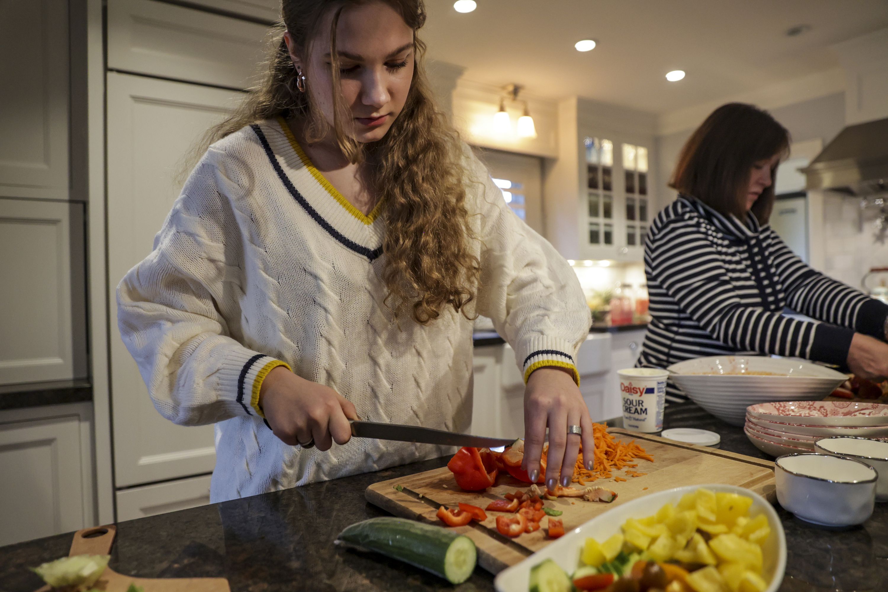 Eva Malezhyk prepares dinner in Salt Lake City on Thursday. One month removed from air raid sirens and missile attacks in Ukraine, Malezhyk is helping streamline the complex process many Ukrainians will soon undergo to stay in the U.S.
