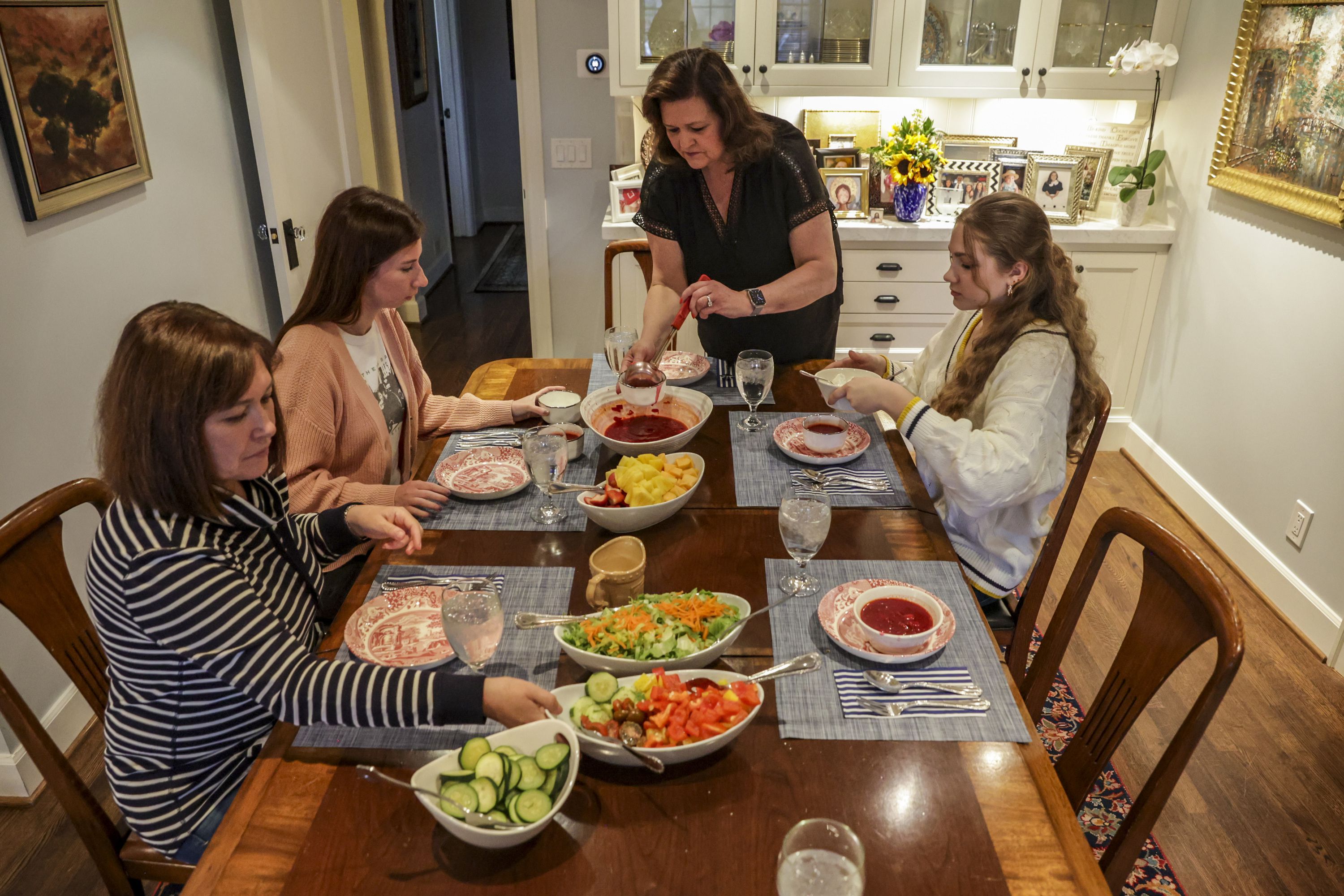 Susan Hansen Porter, who has opened her home to Ukranian refugees, pours some Borscht, a Ukrainian national dish, into the bowl in Salt Lake City on Thursday.