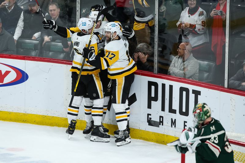 Mar 31, 2022; Saint Paul, Minnesota, USA; Pittsburgh Penguins center Evgeni Malkin (71) celebrates his game winning goal against Minnesota Wild goaltender Cam Talbot (33) with teammates in overtime at Xcel Energy Center.