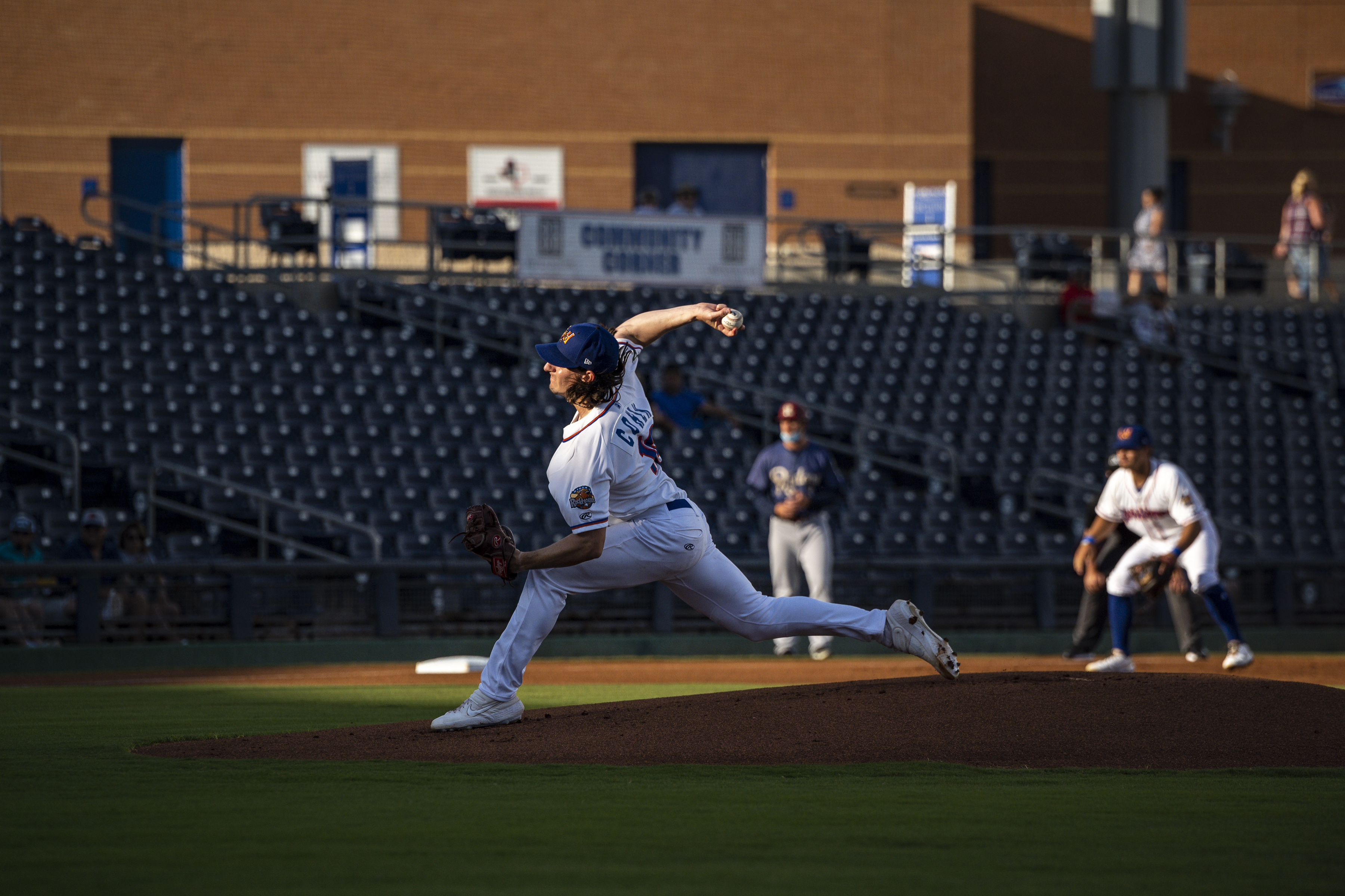 FILE - Midland Rockhounds pitcher Chase Cohen throws during the first inning against the Frisco RoughRiders in a Double-A baseball game Tuesday, May 25, 2021, in Midland, Texas. Minor leaguers with wives and children are finding out days before the start of their seasons that some teams are not taking their families into account as part of a new policy guaranteeing housing for players. MLB initiated a policy for this season mandating that teams provide housing for roughly 90% of minor league players, and the change has taken tremendous stress off many of them.