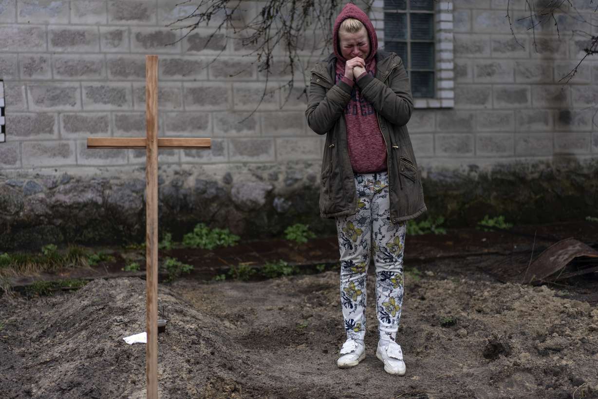 Mariya Ol'hovs'ka, 33, mourns the death of her father Valerii Ol'hovs'kyi, 72, killed by a Russian missile on March 30 near his house, on the outskirts of Kyiv, Ukraine, Friday. Maria and her family buried her father in the garden of their home as they could not bury him in the village cemetery due to fighting between the Ukrainian and Russian armies.