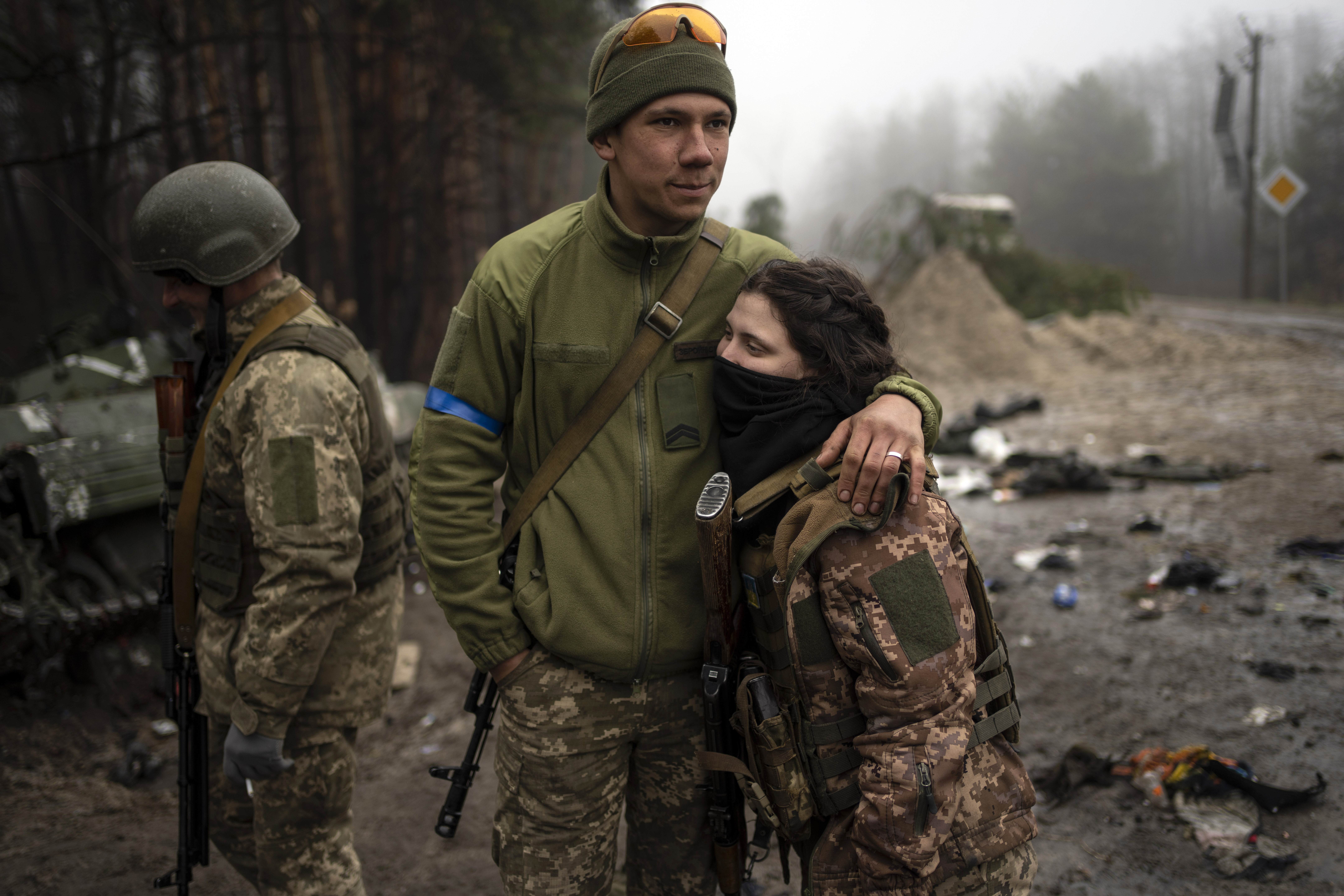 Ukrainian army soldiers, Igor, 23, embraces his wife Dasha, 22, after a military sweep to search for possible remnants of Russian troops after their withdrawal from villages in the outskirts of Kyiv, Ukraine, Friday.
