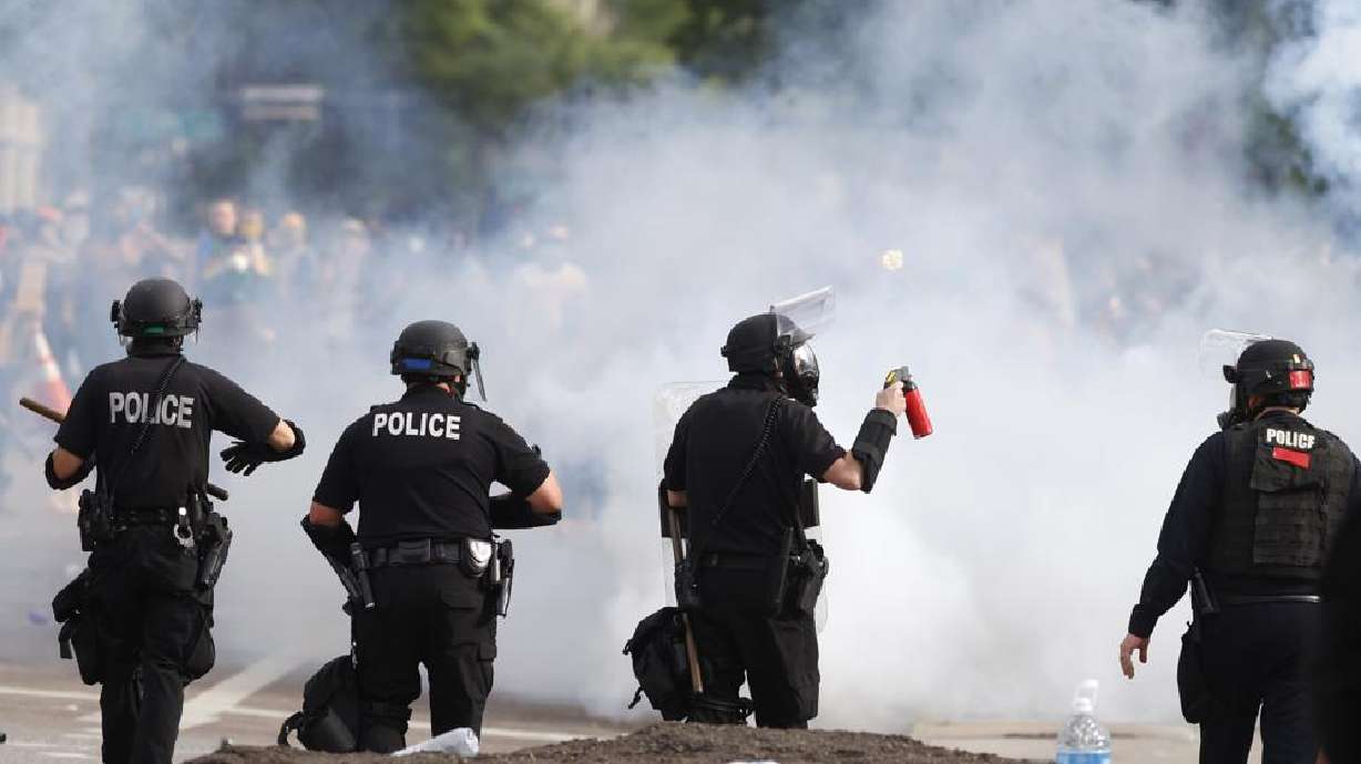 Denver police move during a protest outside the State Capitol over the death of George Floyd, May 30, 2020, in Denver. A federal jury’s $14 million award to Denver protesters injured during 2020 demonstrations over the killing of George Floyd could resonate nationwide as courts weigh more than two dozen similar lawsuits.