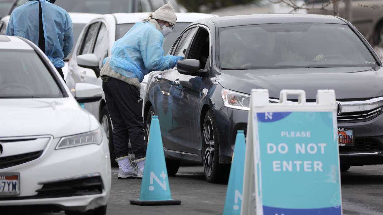 Medical workers test people for COVID-19 outside of the Draper Senior Center in Draper on Jan. 4.