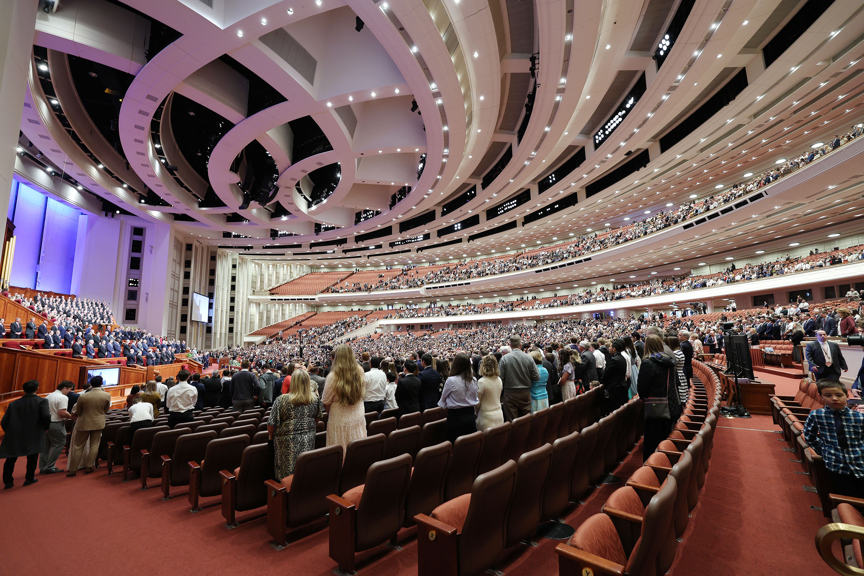 Conferencegoers stand as general authorities enter the Conference Center for The Church of Jesus Christ of Latter-day Saints' 192nd Annual General Conference in Salt Lake City on Saturday.