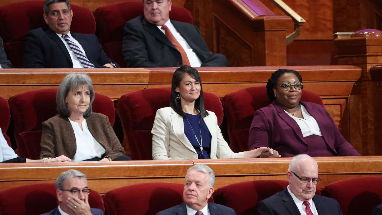 J. Anette Dennis, first counselor of The Church of Jesus Christ of Latter-day Saints' Relief Society, center left, Sister Kristin M. Yee, second counselor of the Relief Society general presidency, and Sister Tracy Y. Browning, second counselor in the Primary general presidency, take their seats during the church's 192nd Annual General Conference at the Conference Center in Salt Lake City on Saturday.