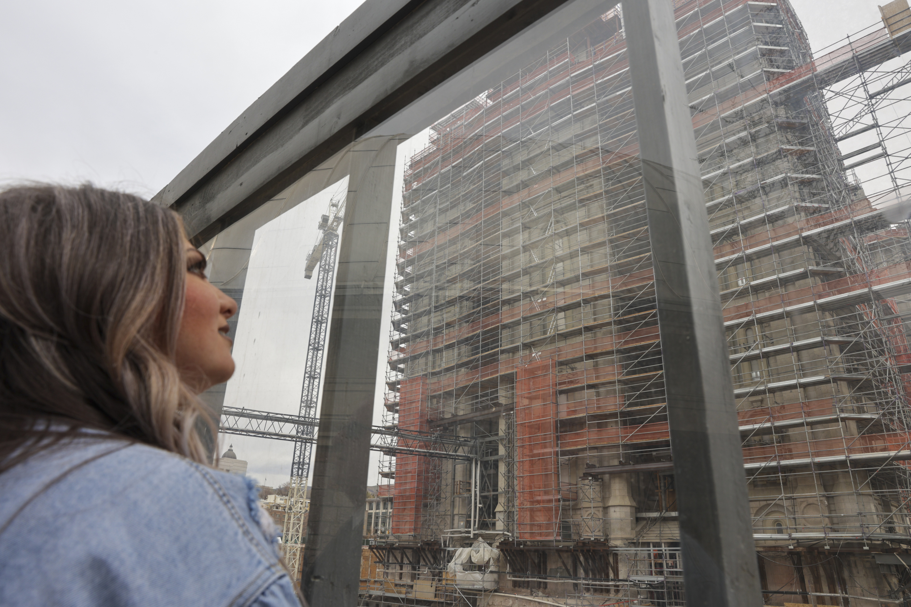 Sierra Gilmore looks at the Salt Lake Temple, which is under renovation, after a Saturday general conference session of The Church of Jesus Christ of Latter-day Saints in Salt Lake City.