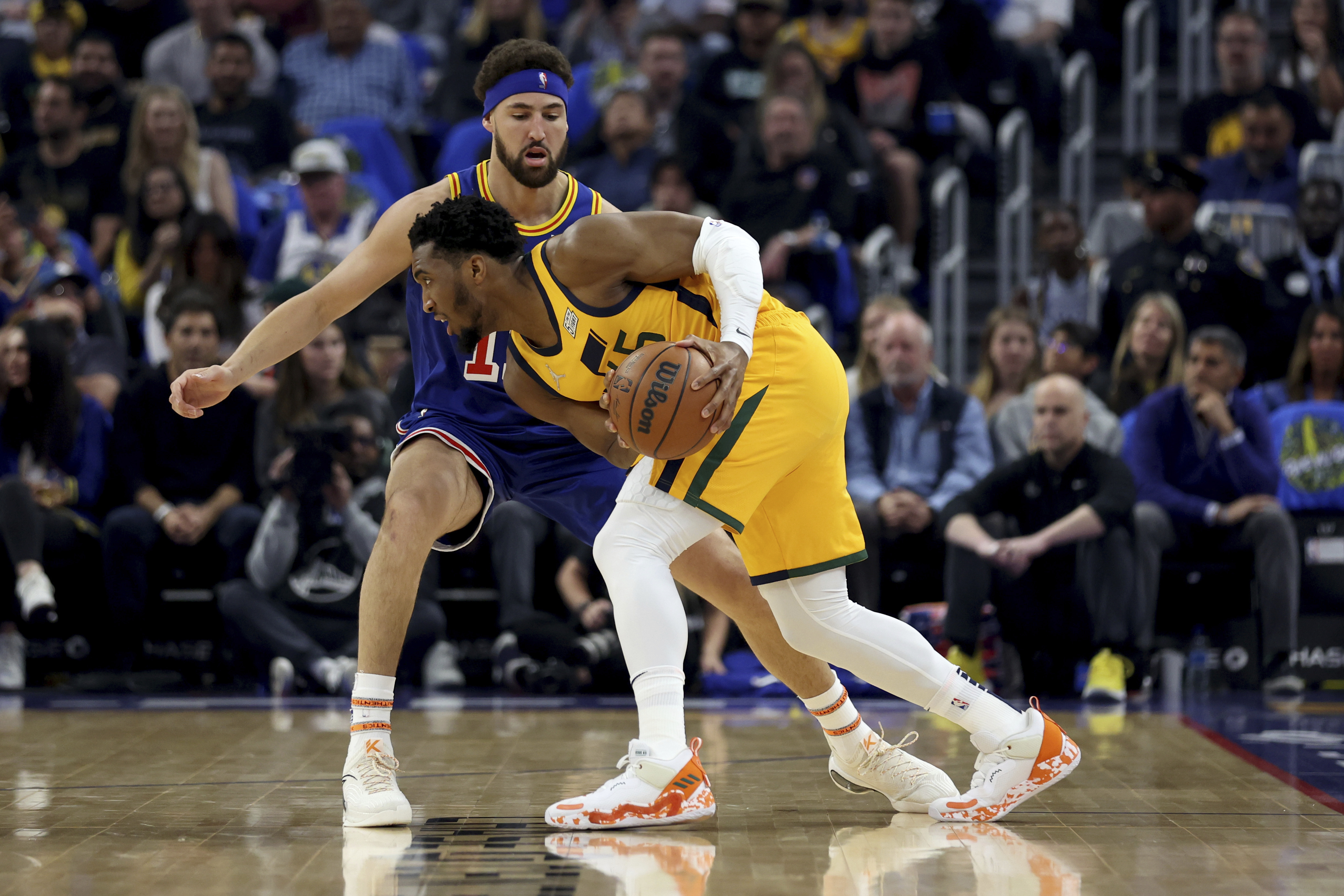 Utah Jazz guard Donovan Mitchell is defended by Golden State Warriors guard Klay Thompson (11) during the first half of an NBA basketball game in San Francisco, Saturday, April 2, 2022. 

