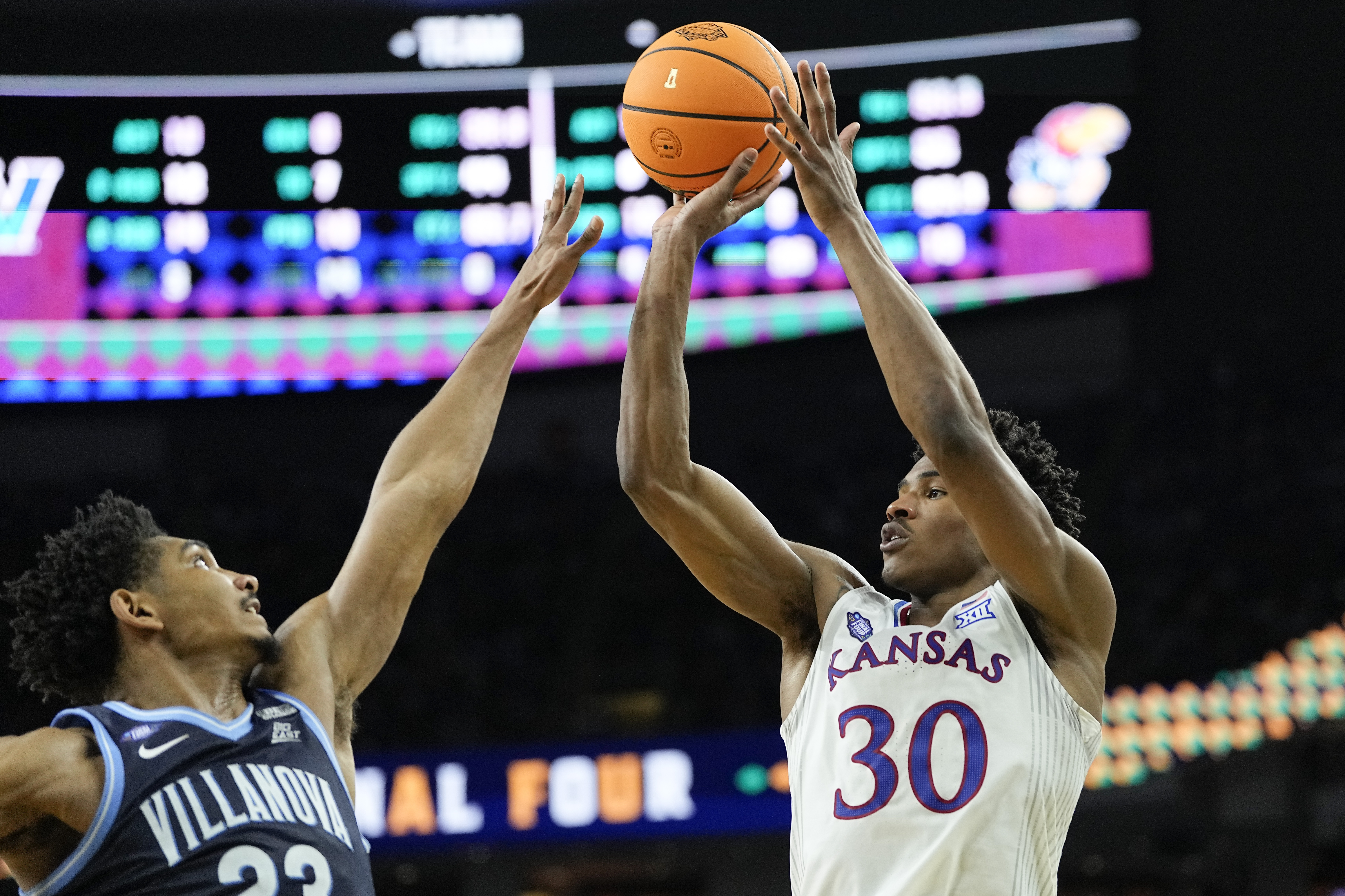 Kansas guard Ochai Agbaji (30) shoots over Villanova forward Jermaine Samuels during the second half of a college basketball game in the semifinal round of the Men's Final Four NCAA tournament, Saturday, April 2, 2022, in New Orleans. 