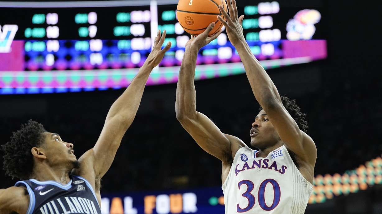 Kansas guard Ochai Agbaji (30) shoots over Villanova forward Jermaine Samuels during the second half of a college basketball game in the semifinal round of the Men's Final Four NCAA tournament, Saturday, April 2, 2022, in New Orleans.
